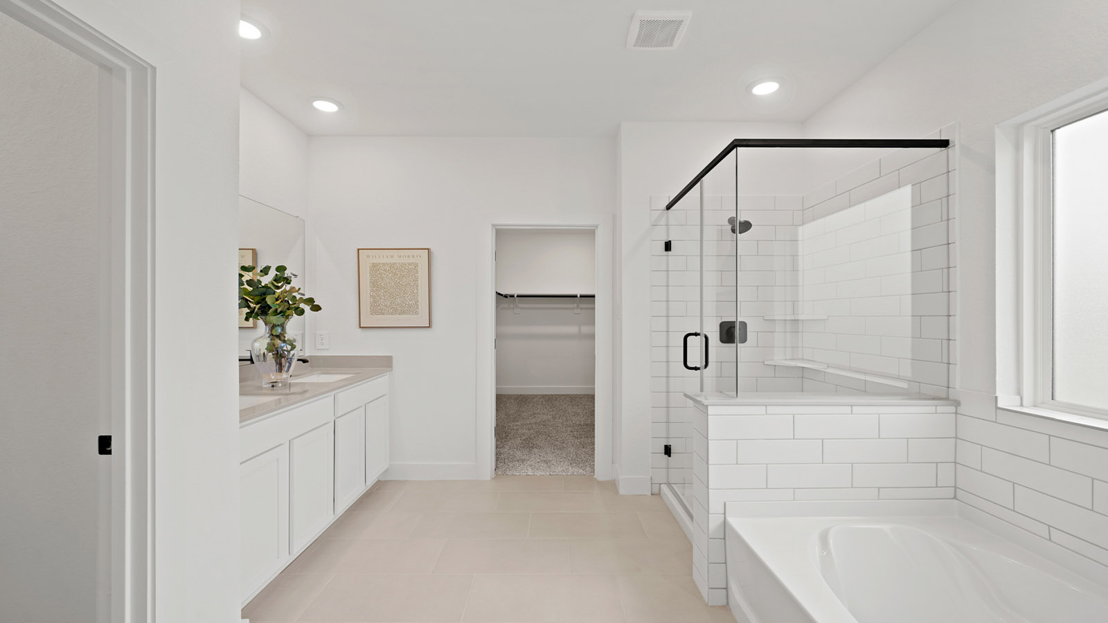 Primary bathroom with soaker tub and tile shower with semi frameless glass in Montgomery TX