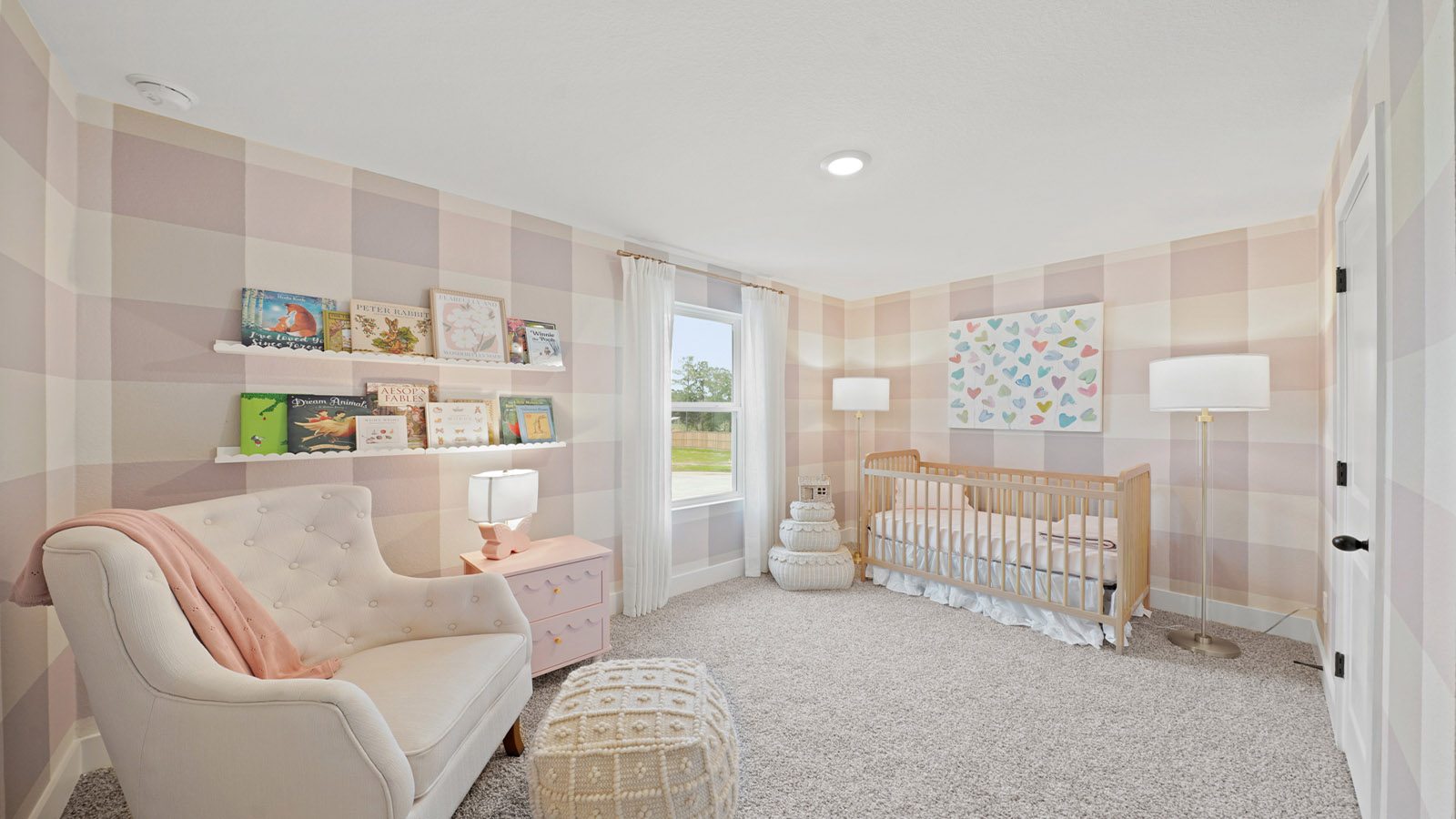 Second level secondary bedroom with carpet flooring and bright window