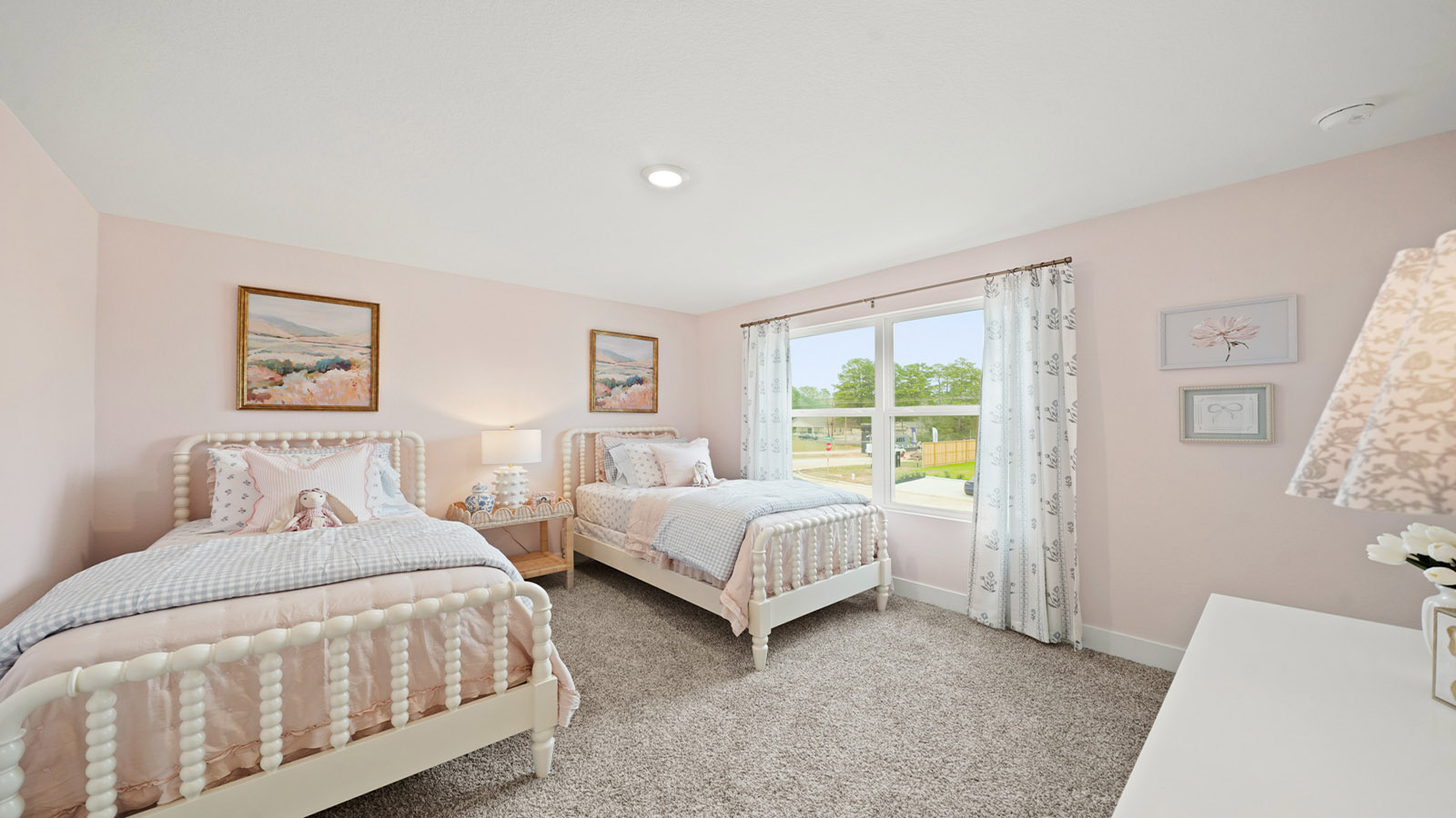 Second level secondary bedroom with carpet flooring and bright window