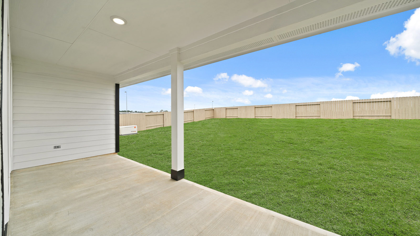 covered patio with jamies hardie siding and overhead lighting