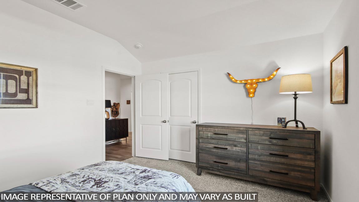 Secondary bedroom with shag carpet flooring and bright window