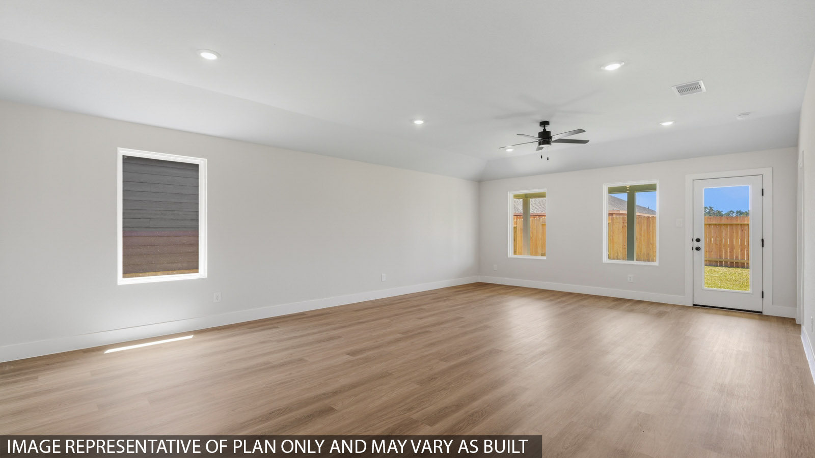 Spacious living area with vinyl flooring and bright windows in Montgomery TX
