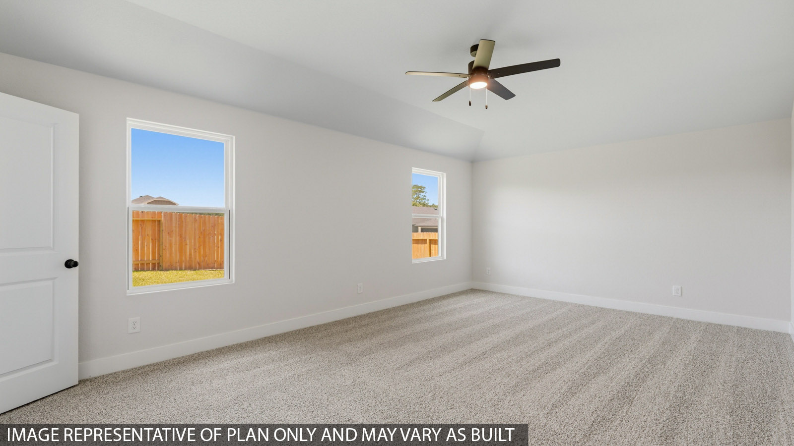 Large Primary bedroom with shag carpet flooring and bright window