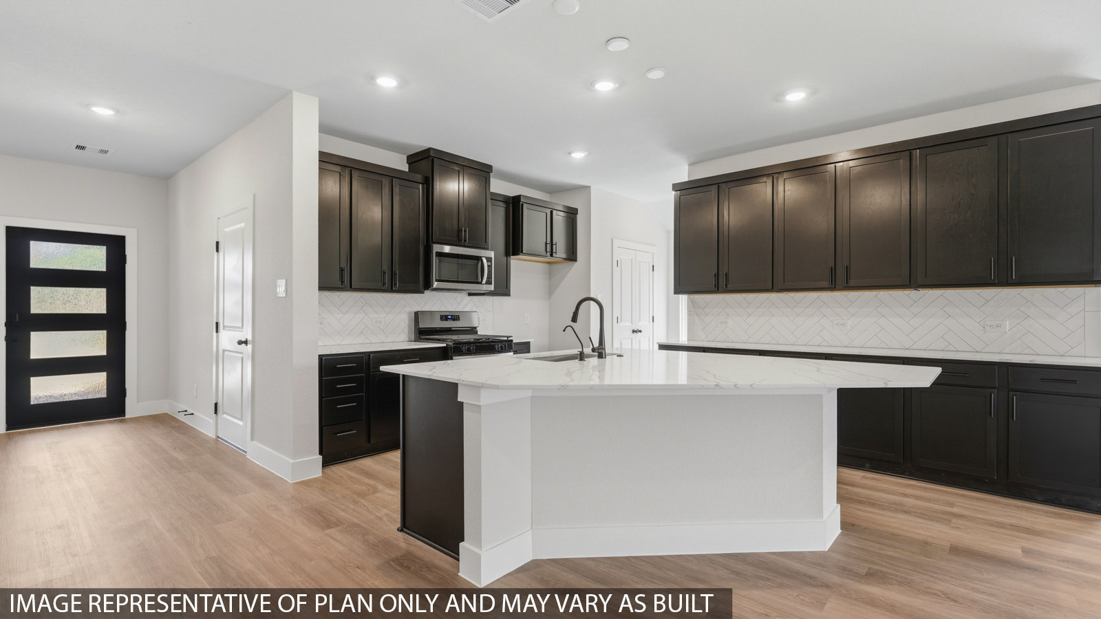 Kitchen with stainless steel appliances, quartz countertops and modern hardware and an island and vinyl floor