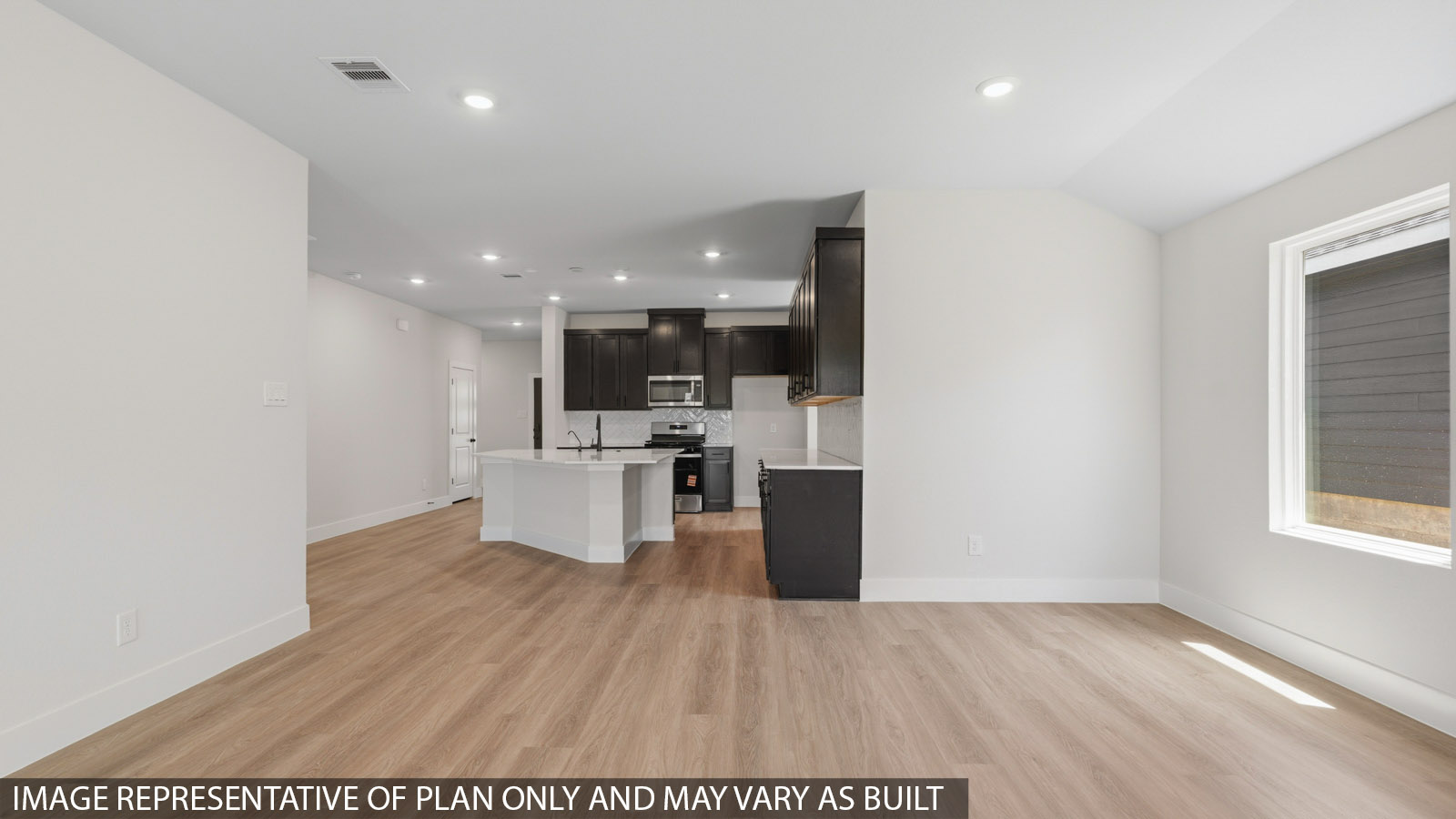 Spacious living area with vinyl flooring and bright windows in Montgomery TX