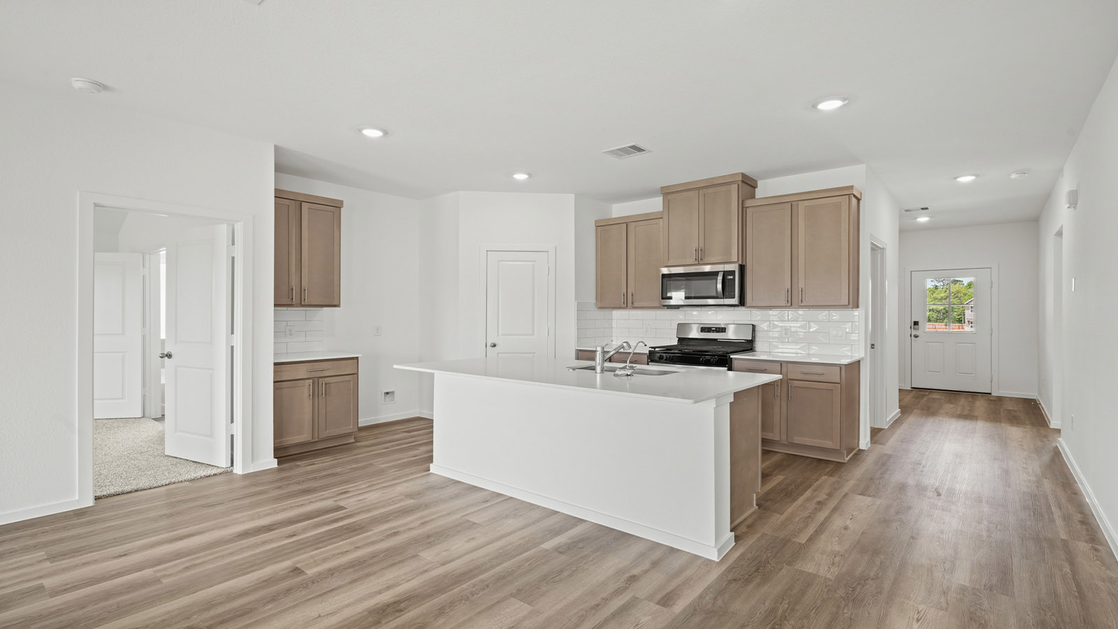 Kitchen with an island and vinyl floor