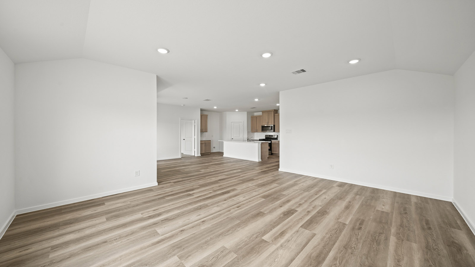 Spacious living area with vinyl flooring