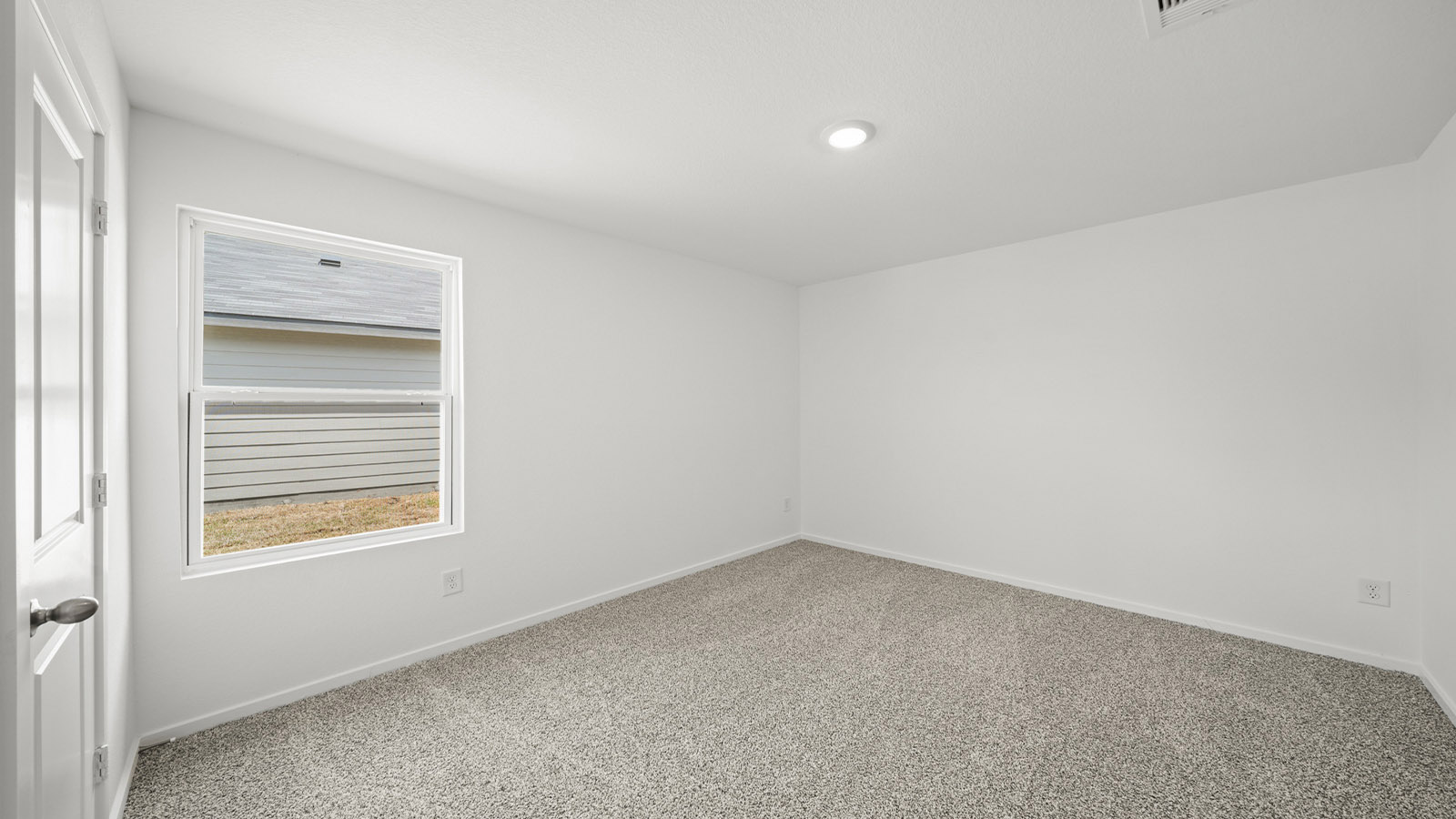 Secondary bedroom with carpet flooring