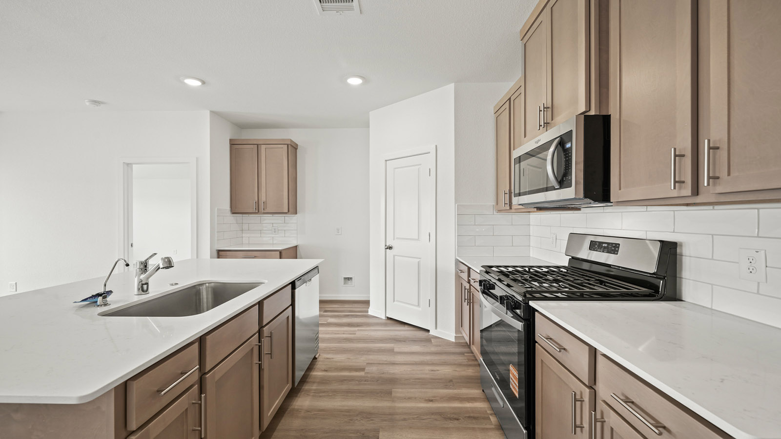 Kitchen with an island and vinyl floor