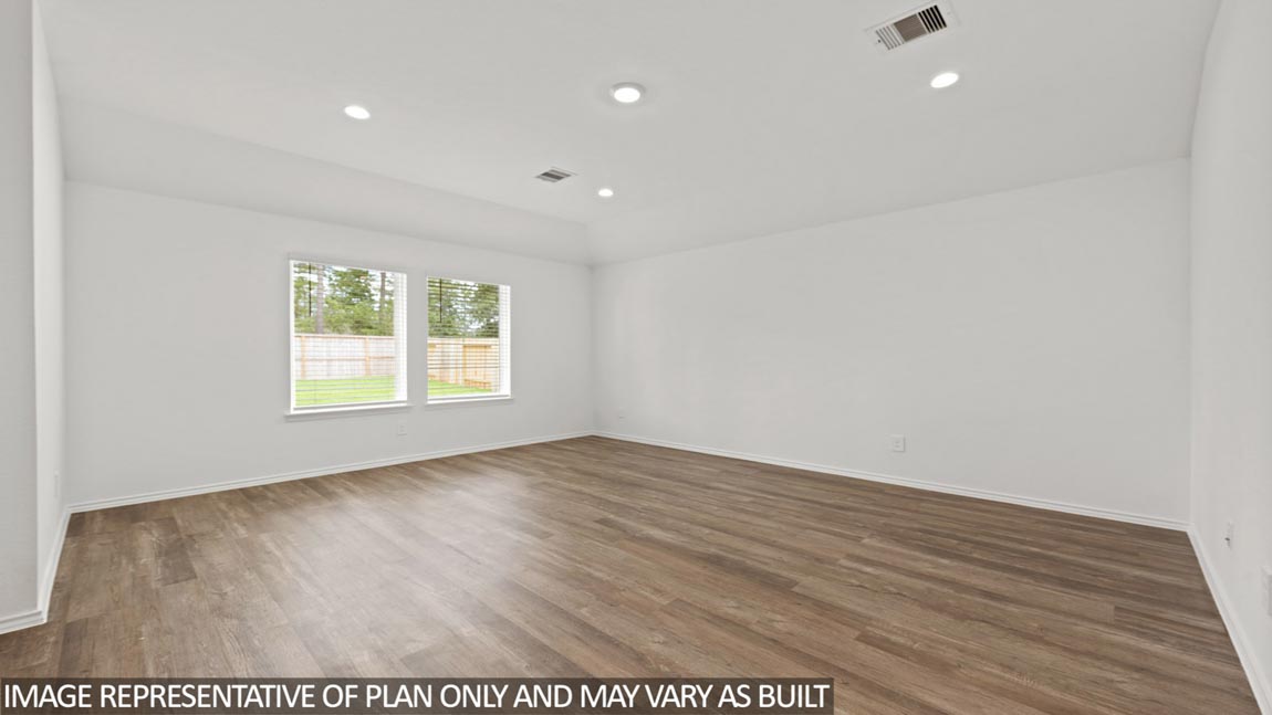 Spacious living area with vinyl flooring