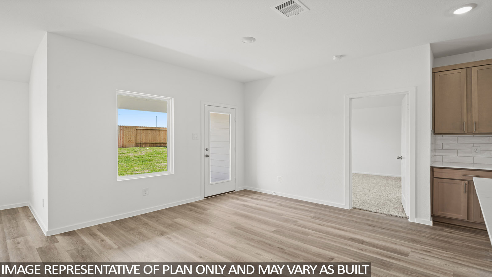 Spacious living area with vinyl flooring