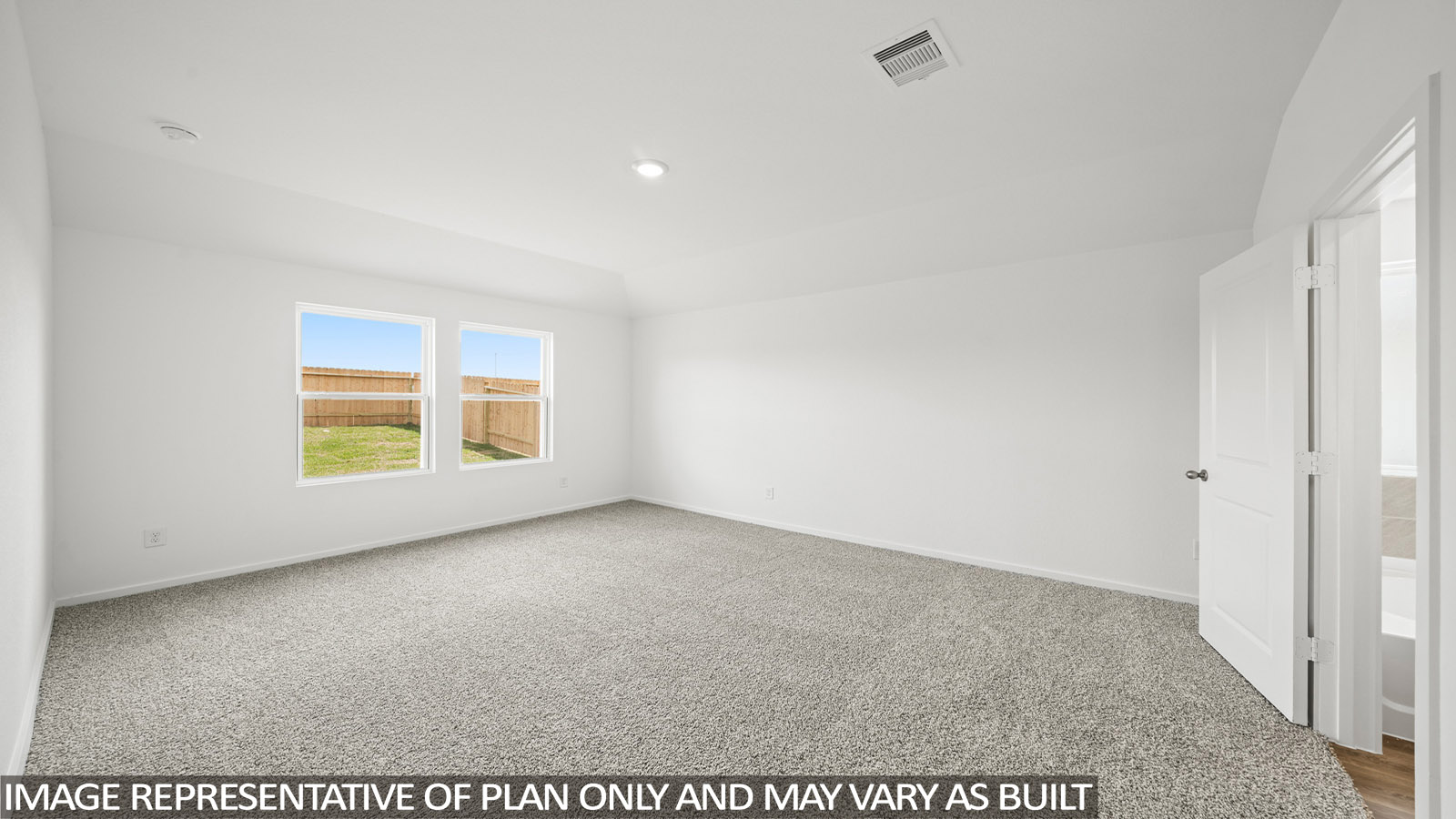 Primary bedroom with carpet flooring