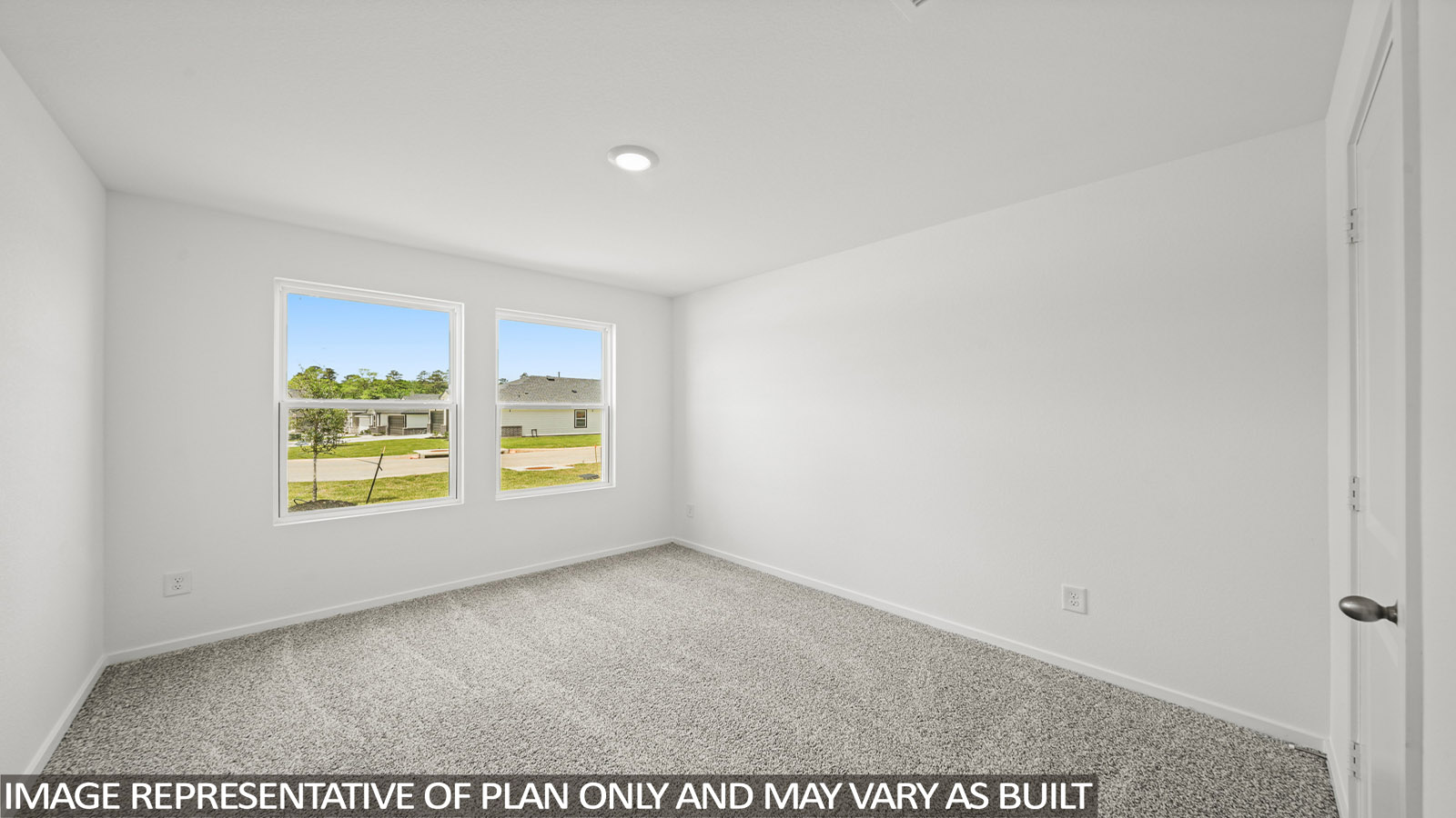 Secondary bedroom with carpet flooring