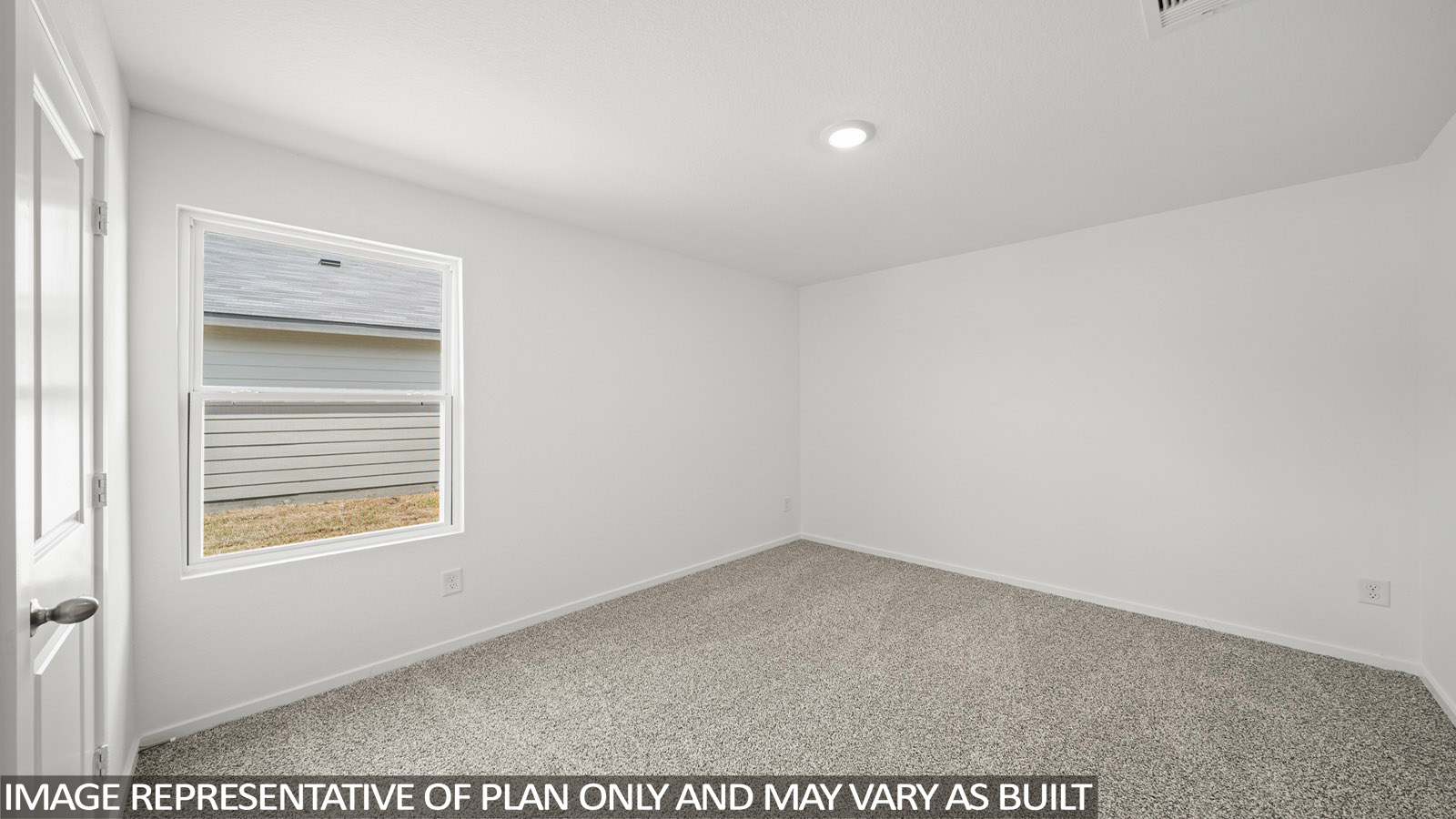 Secondary bedroom with carpet flooring