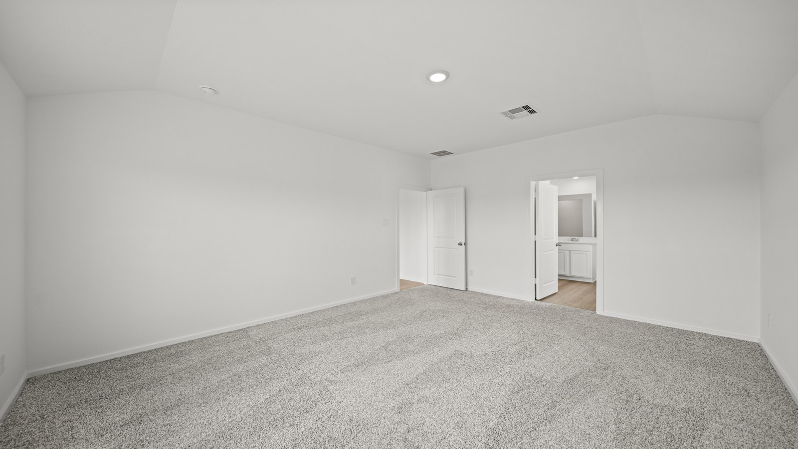 Primary bedroom with carpet flooring