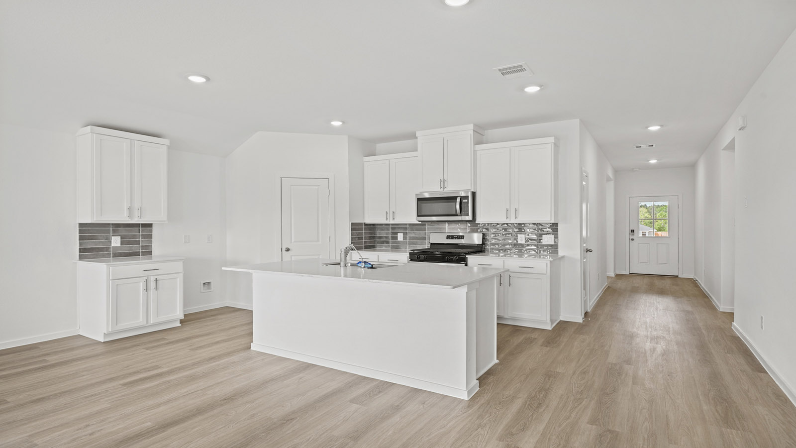 Kitchen with an island and vinyl floor