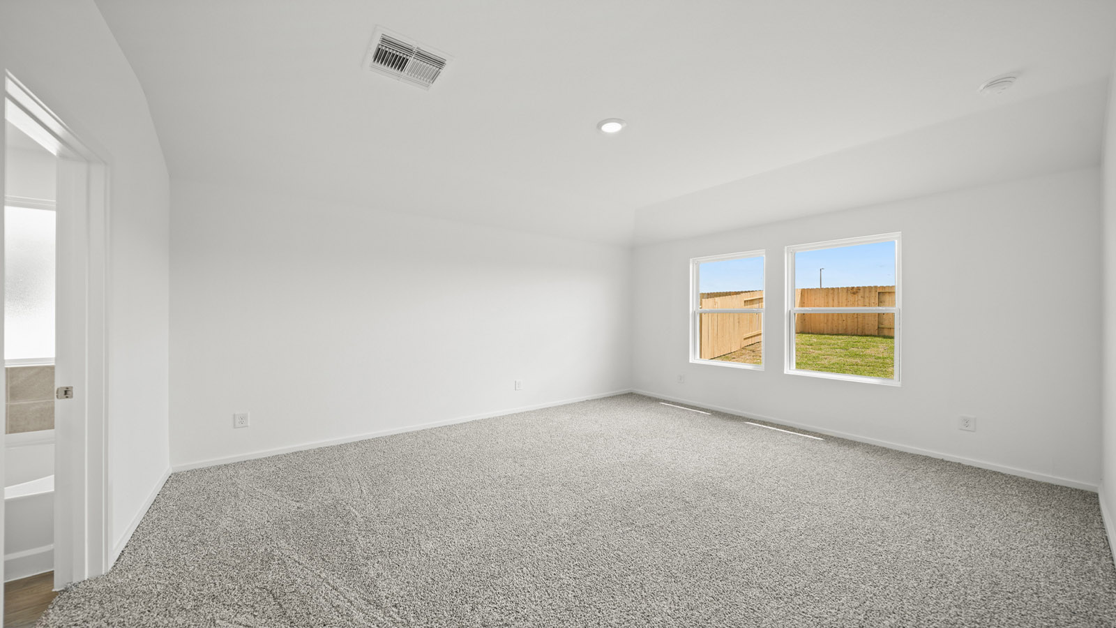 Primary bedroom with carpet flooring