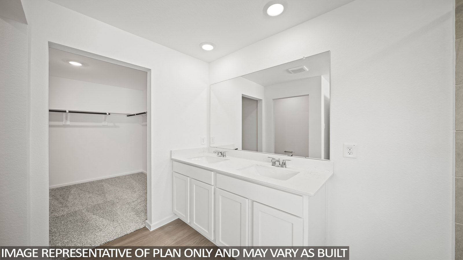 primary bathroom with dual vanities