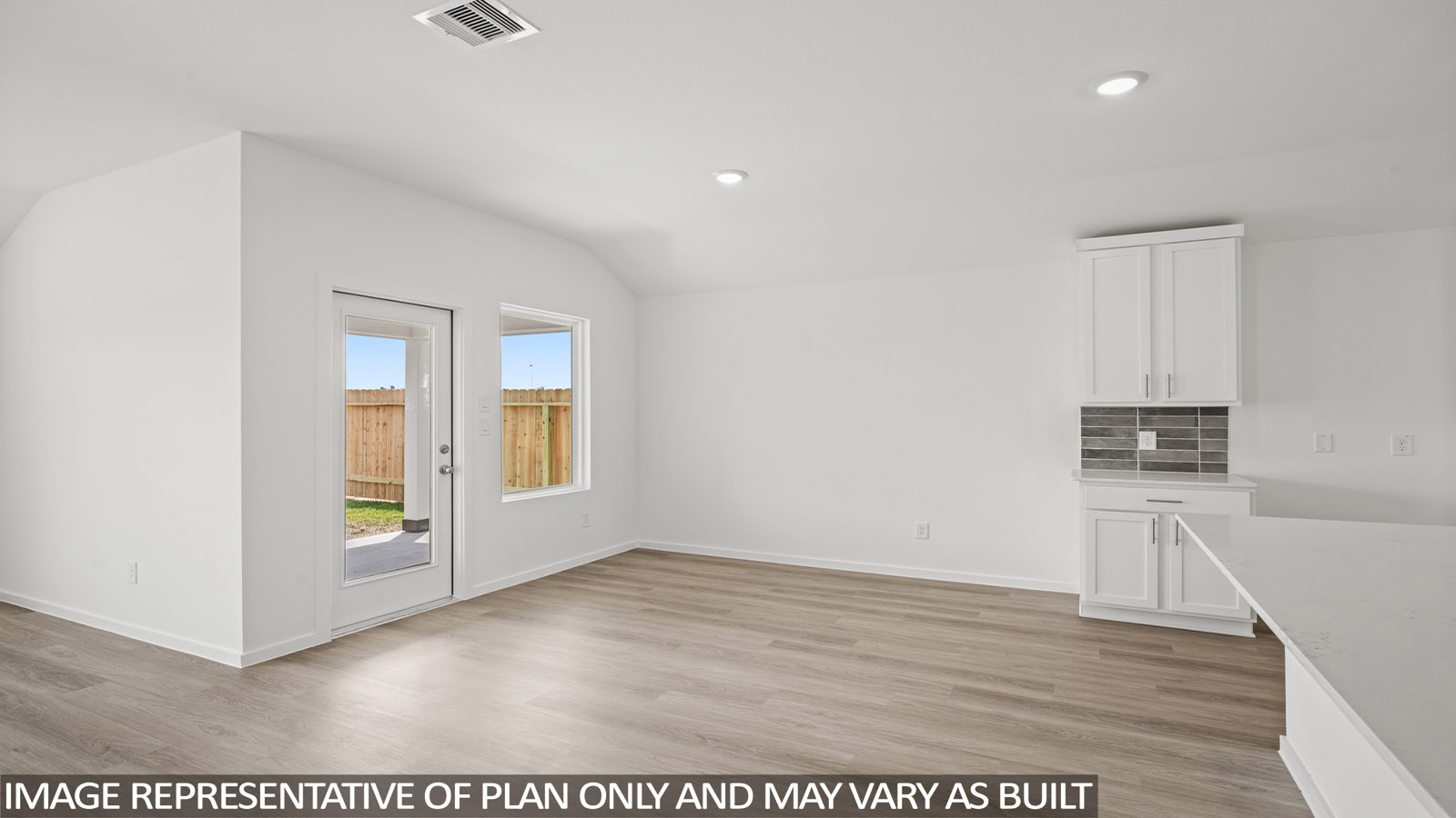 Spacious living area with vinyl flooring