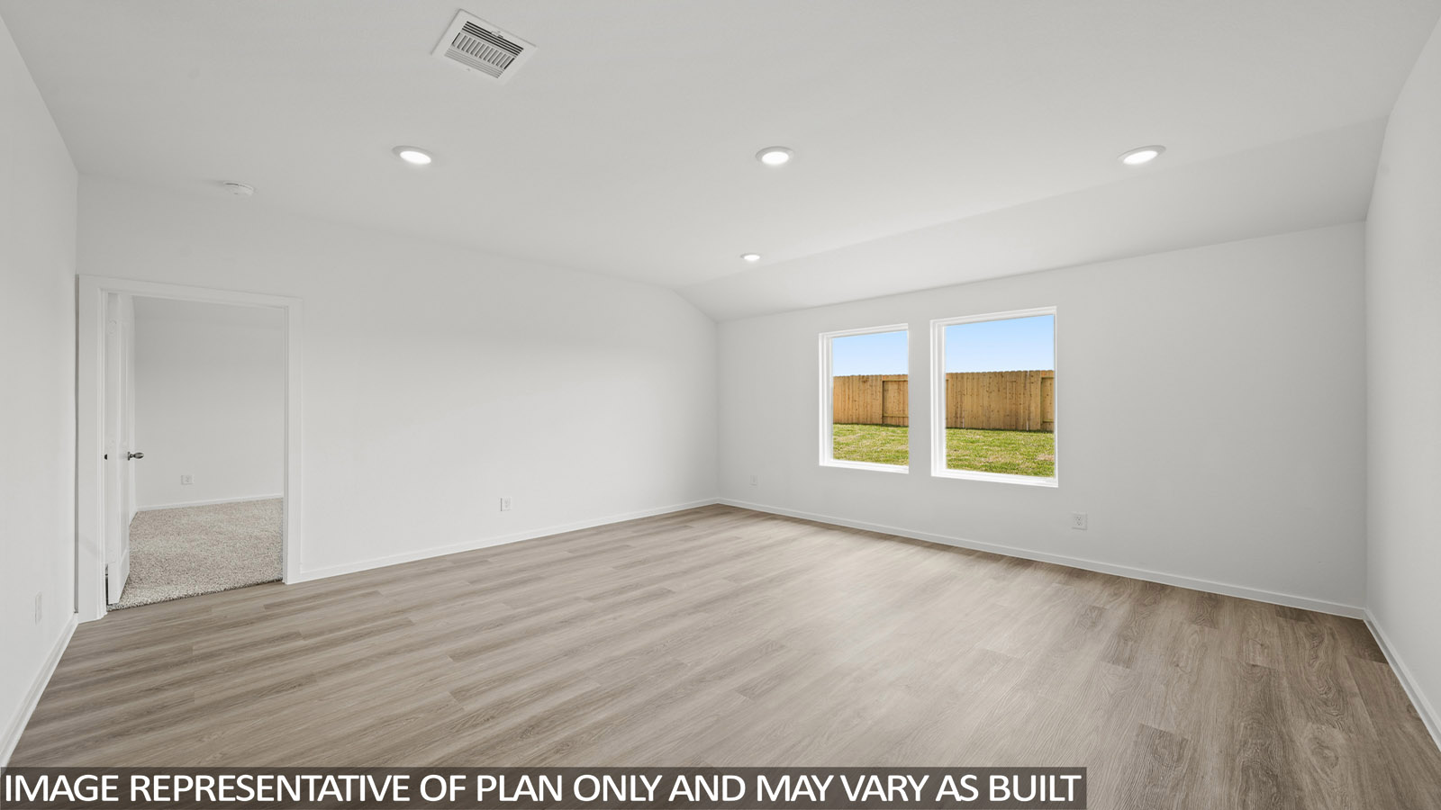 Spacious living area with vinyl flooring