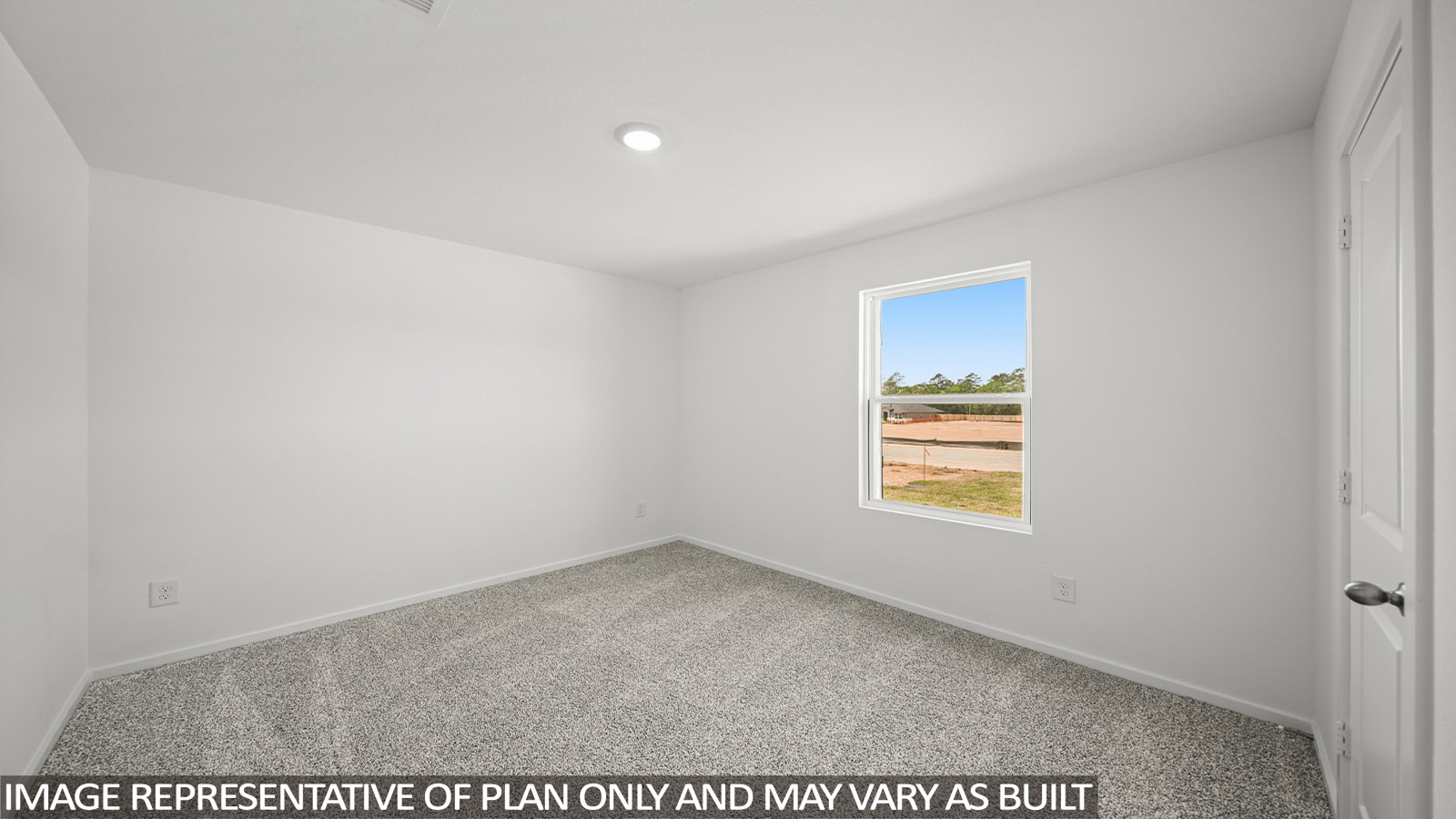 Secondary bedroom with carpet flooring