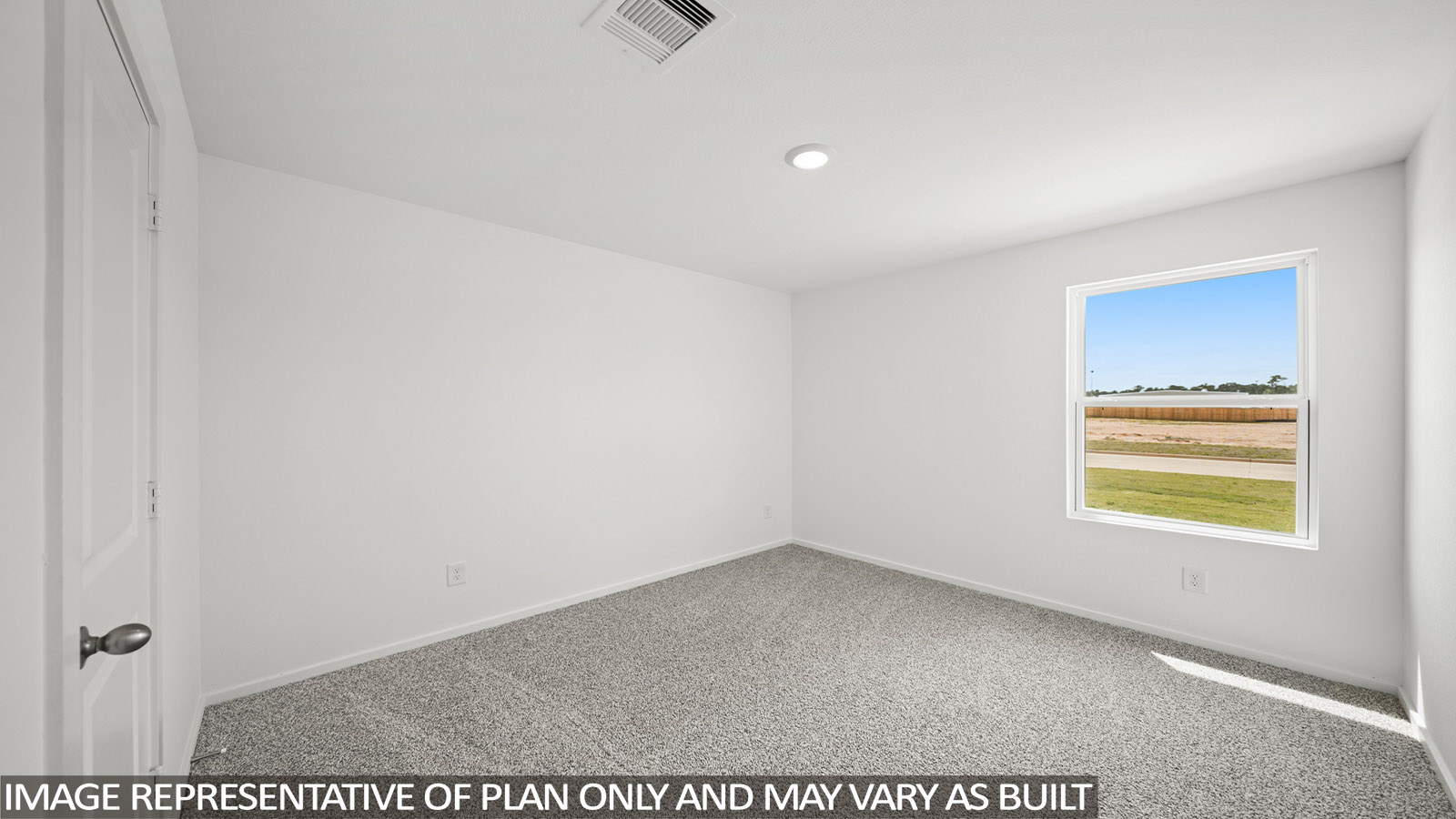 Secondary bedroom with carpet flooring