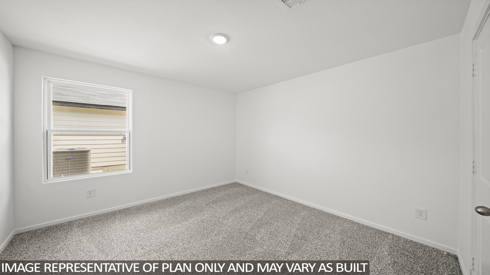 Secondary bedroom with carpet flooring