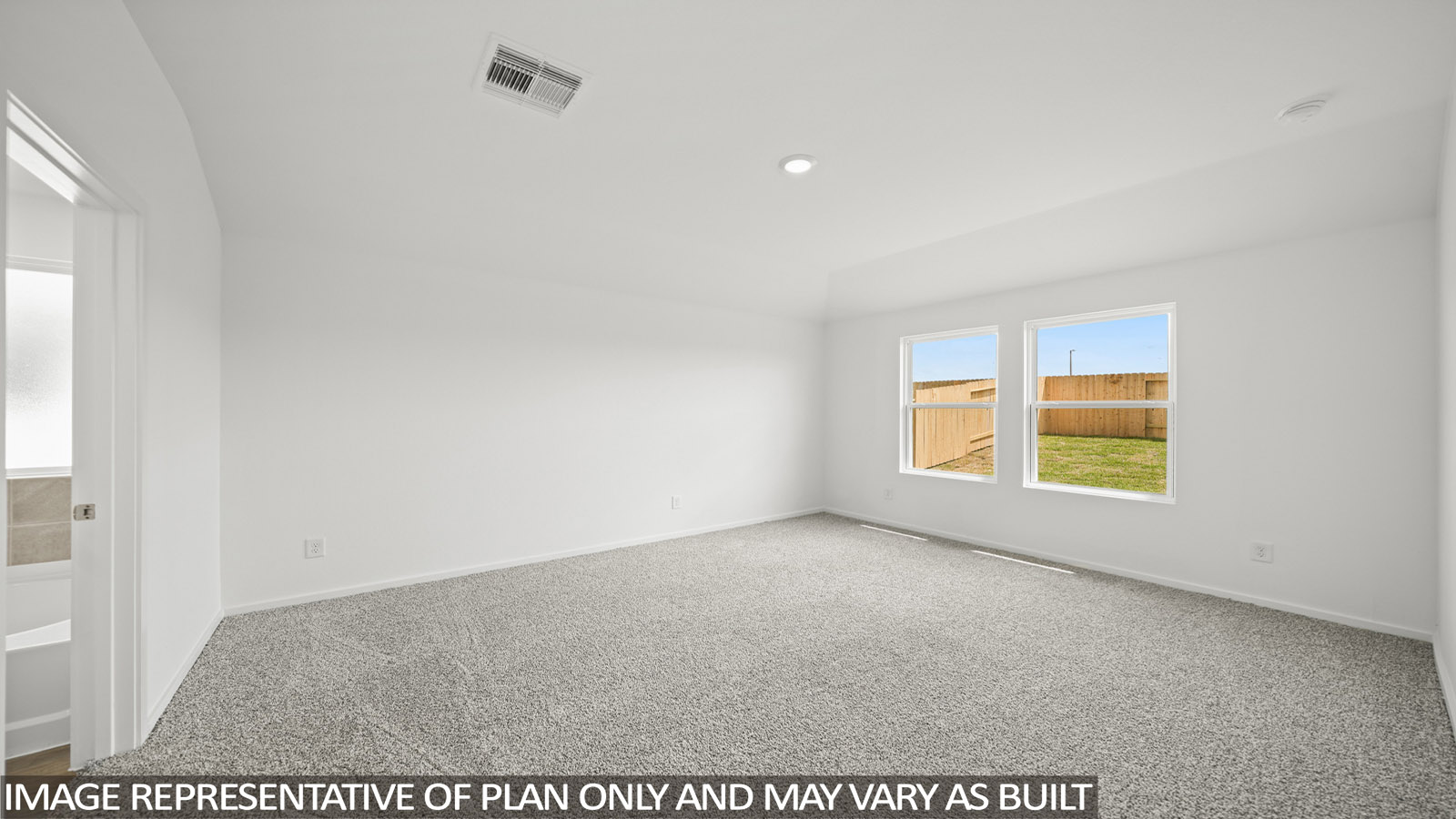 Primary bedroom with carpet flooring
