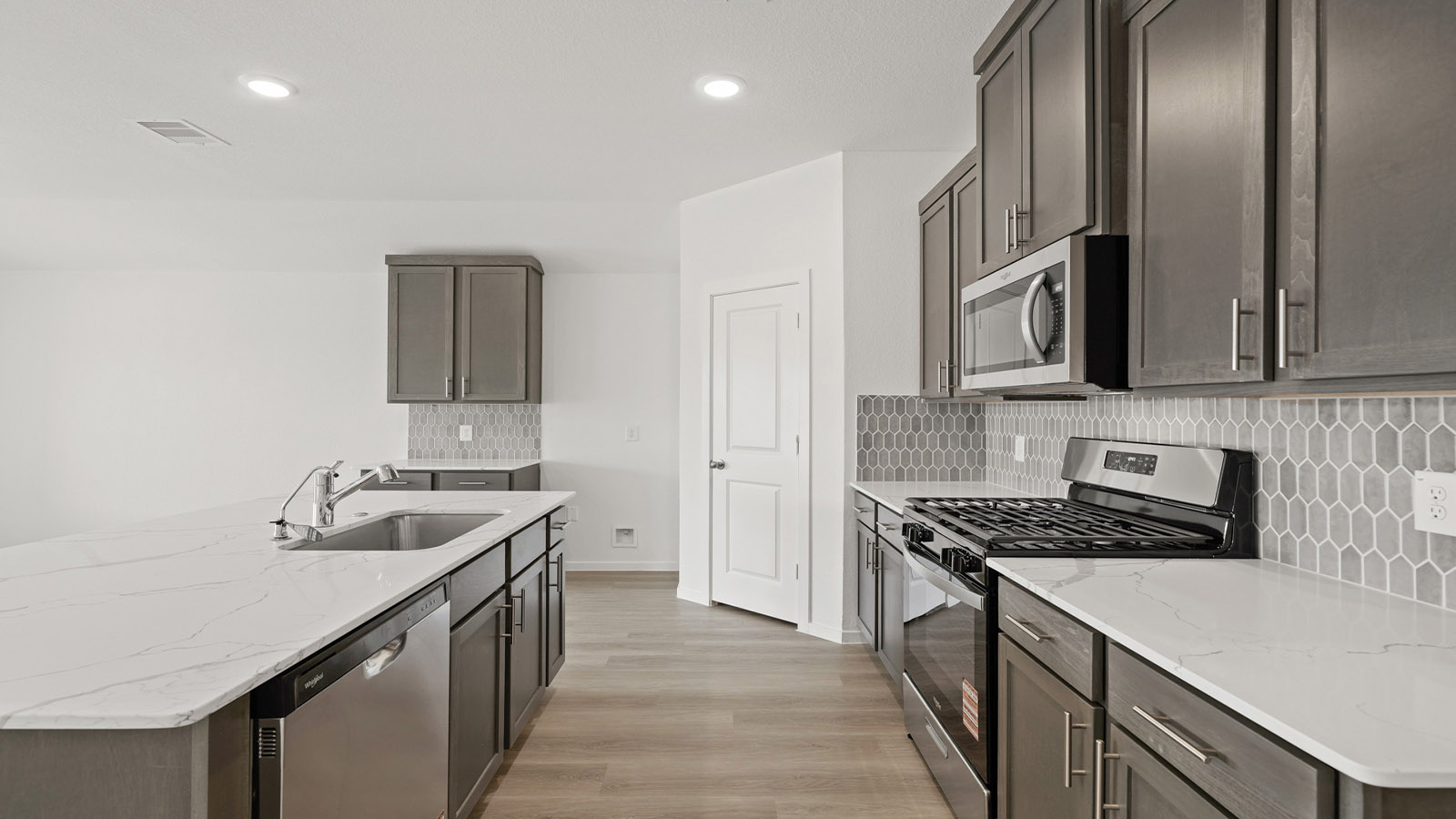 Kitchen with an island and vinyl floor