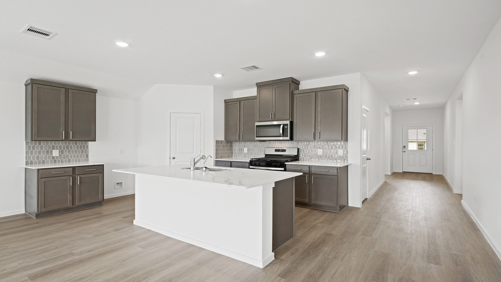 Kitchen with an island and vinyl floor