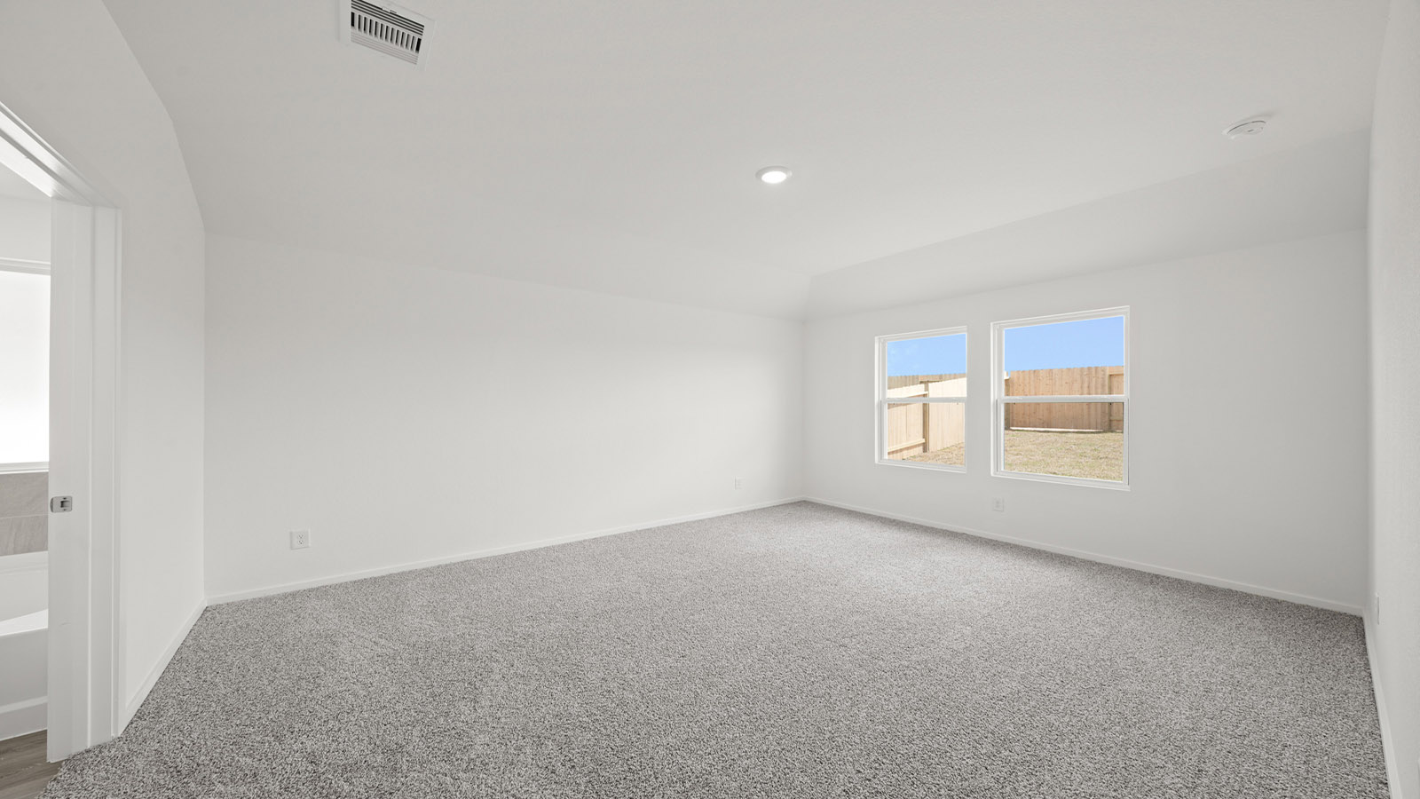 Primary bedroom with carpet flooring