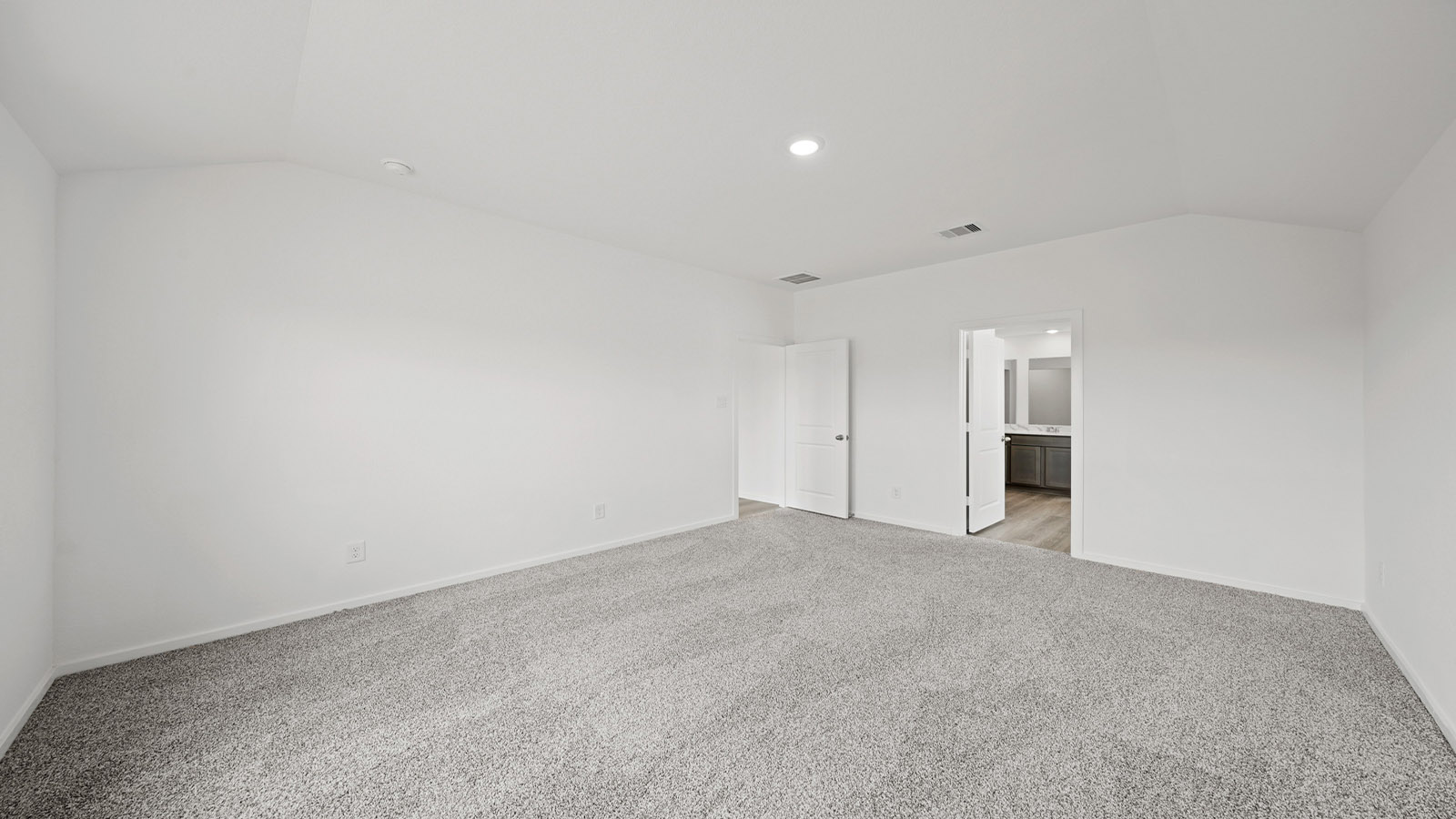 Primary bedroom with carpet flooring