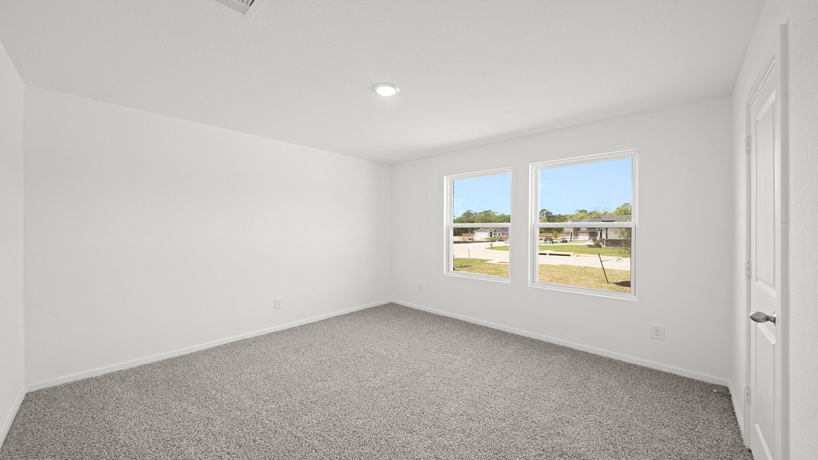 Secondary bedroom with carpet flooring