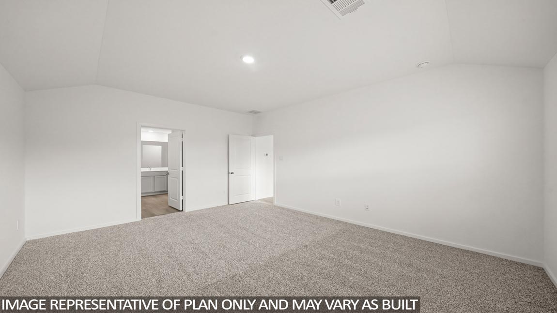 Primary bedroom with carpet flooring