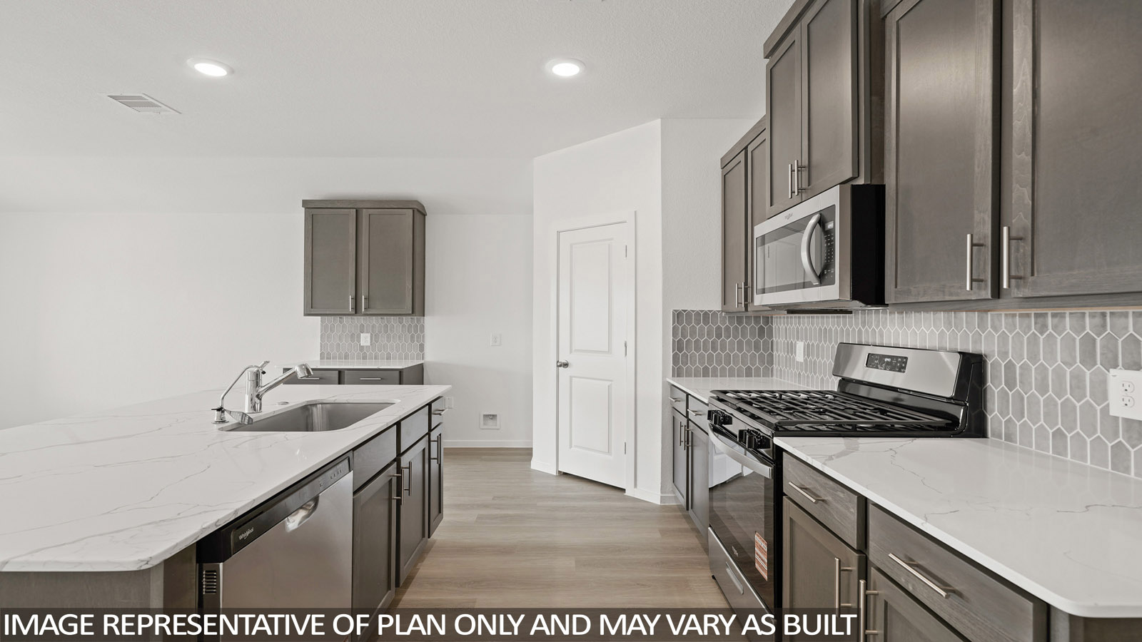 Kitchen with an island and vinyl floor