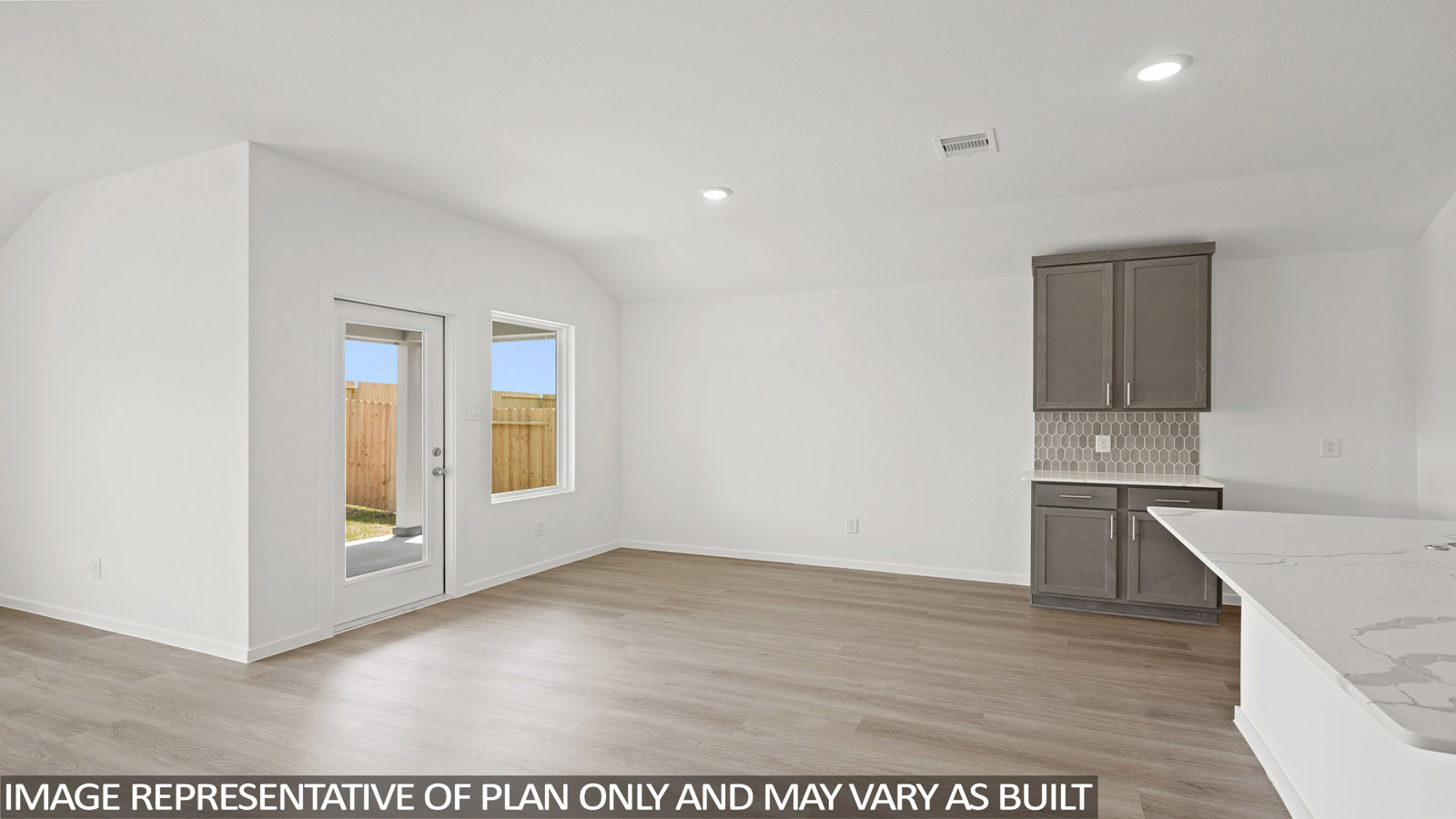 Spacious living area with vinyl flooring