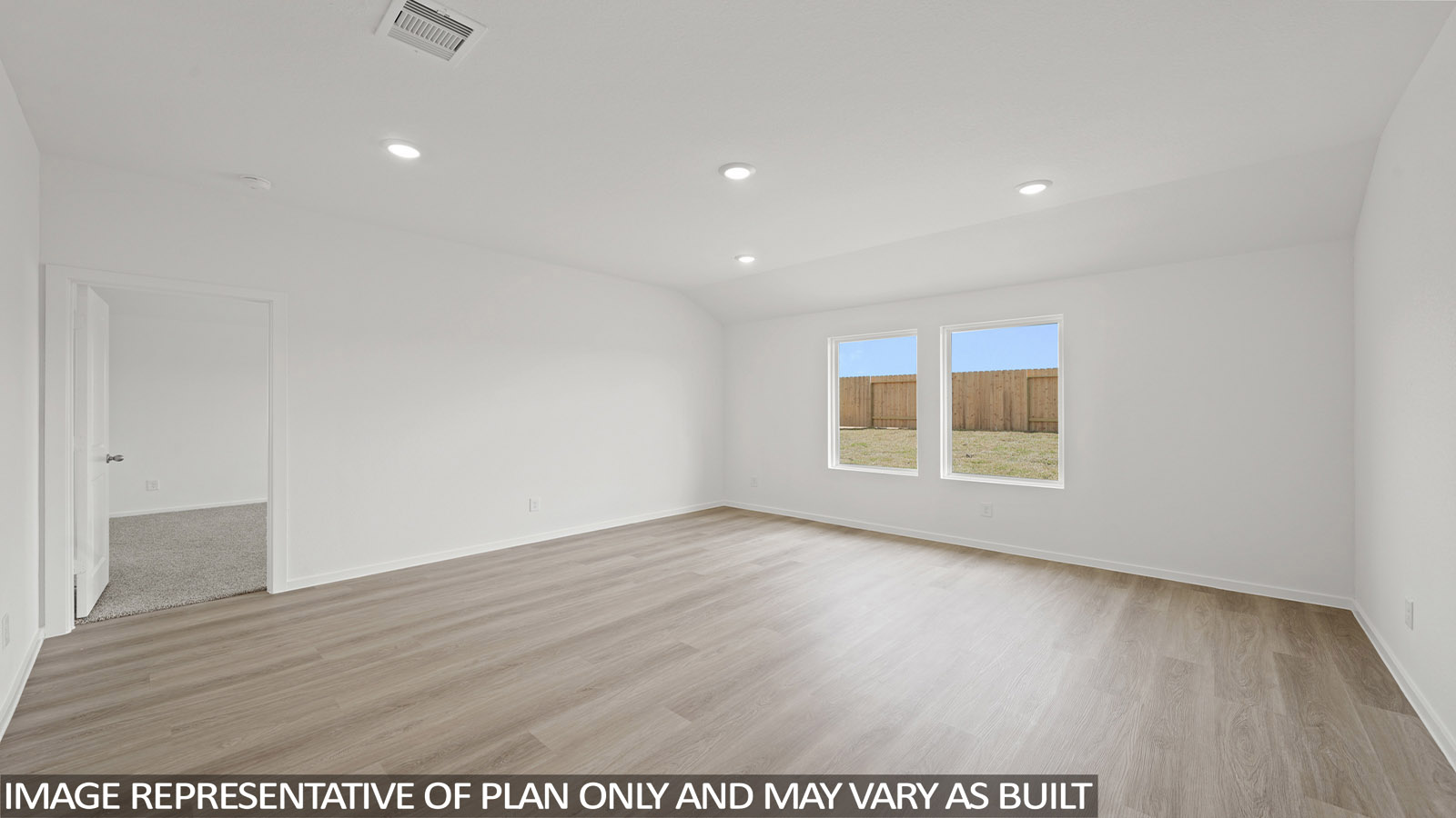 Spacious living area with vinyl flooring