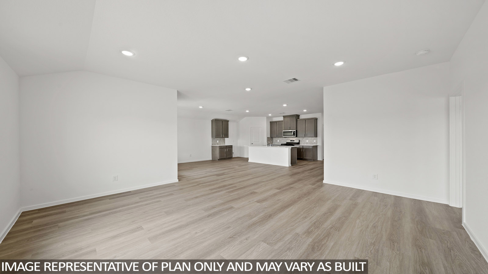 Spacious living area with vinyl flooring