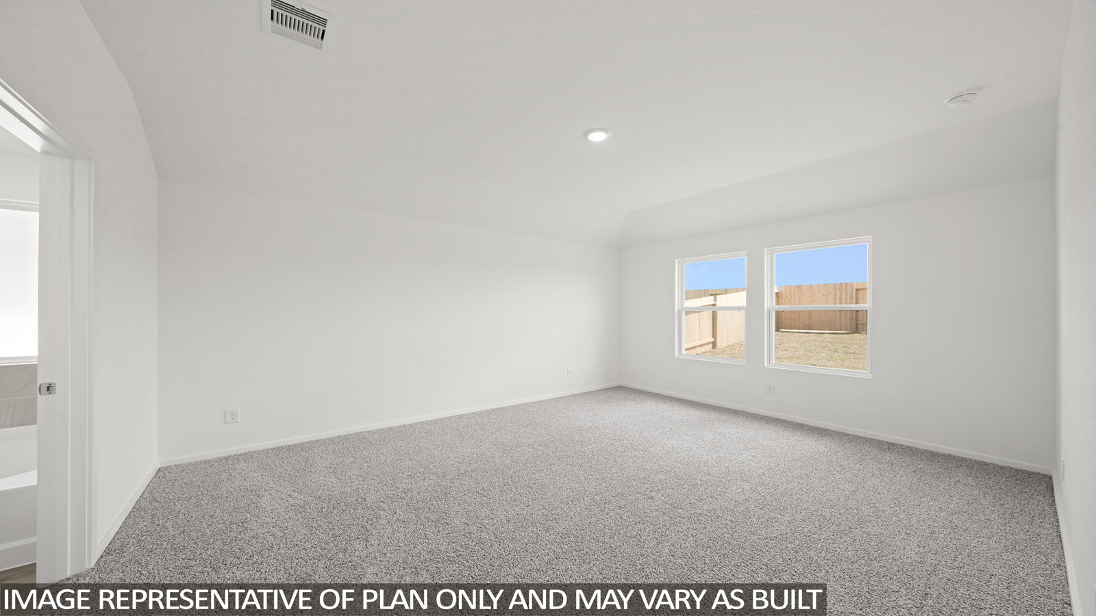 Primary bedroom with carpet flooring