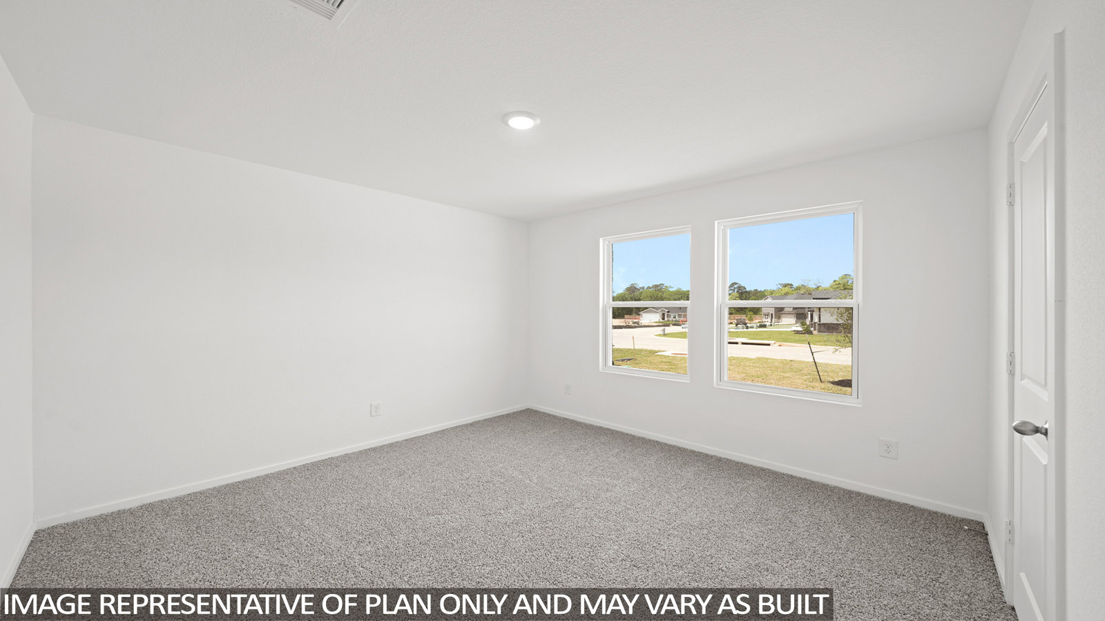 Secondary bedroom with carpet flooring