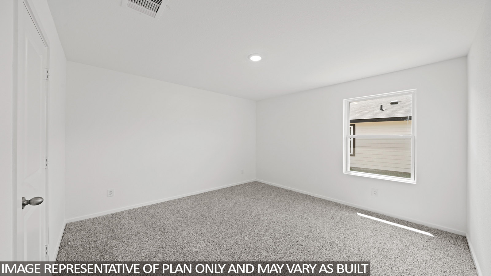 Secondary bedroom with carpet flooring