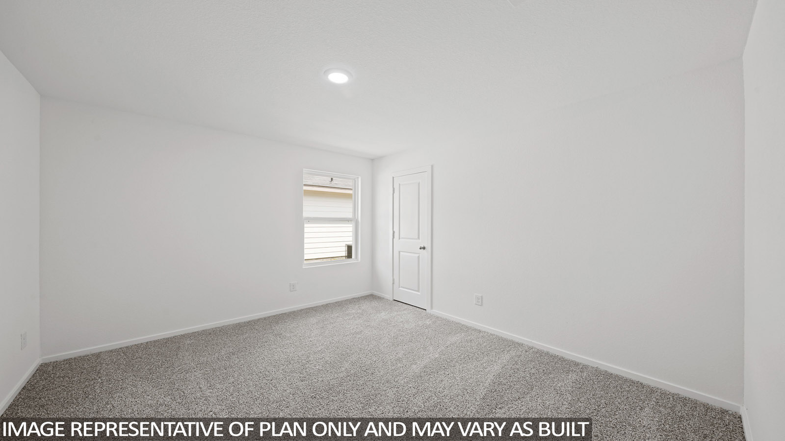 Secondary bedroom with carpet flooring