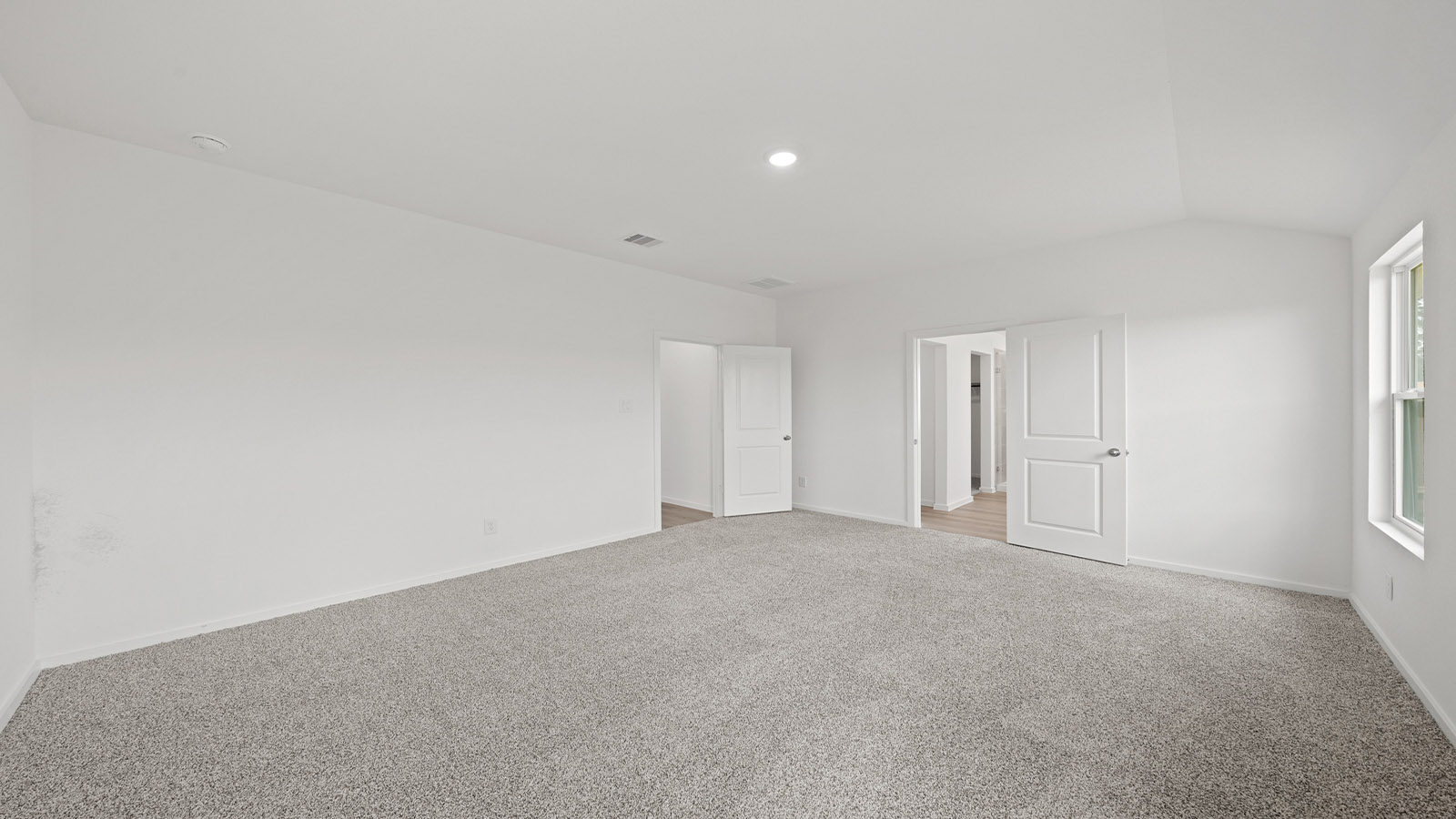 Primary bedroom with carpet flooring