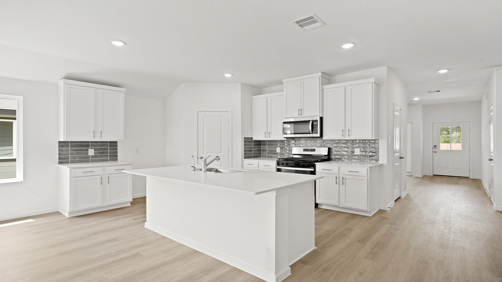 Kitchen with an island and vinyl floor