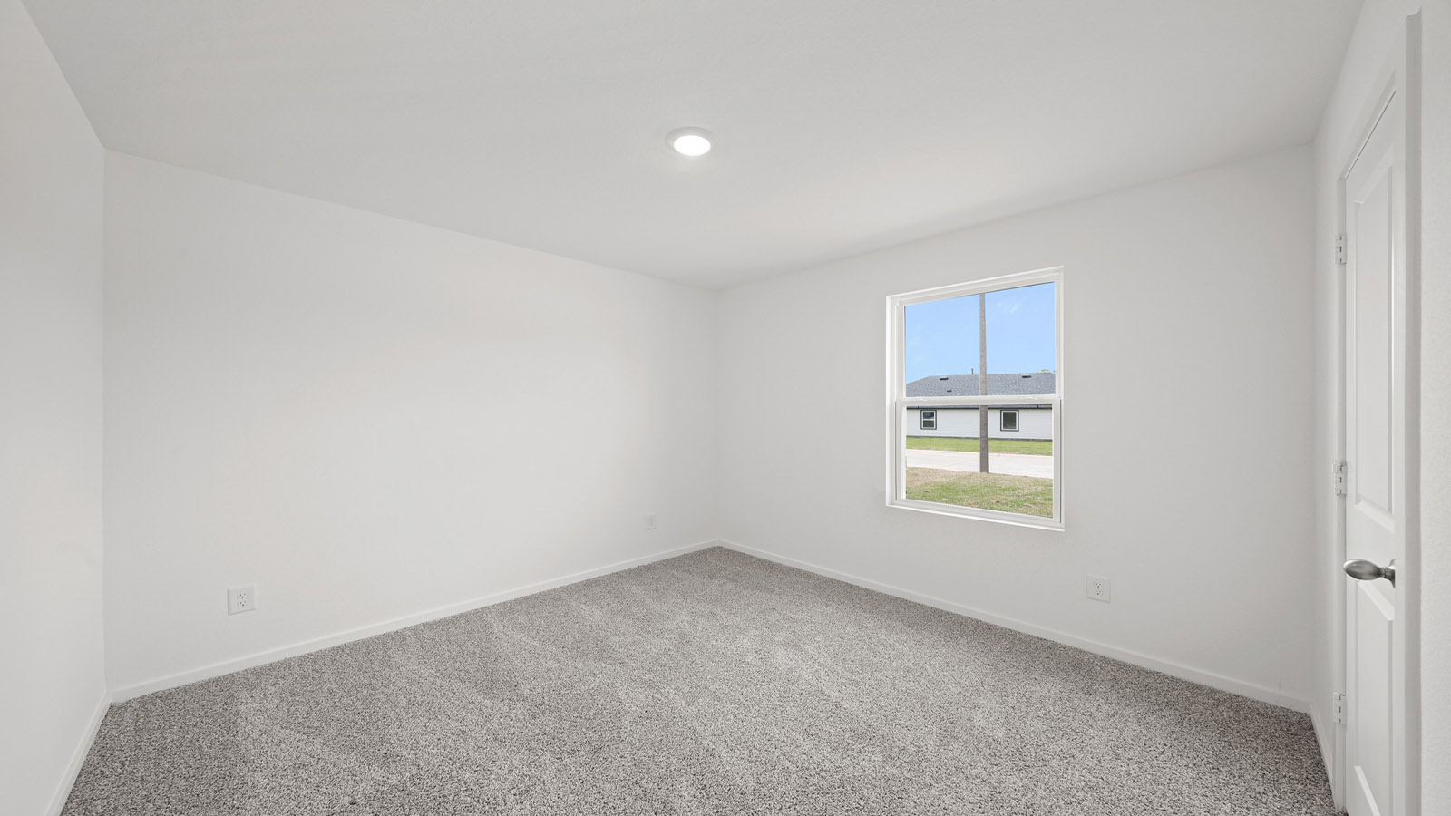 Secondary bedroom with carpet flooring