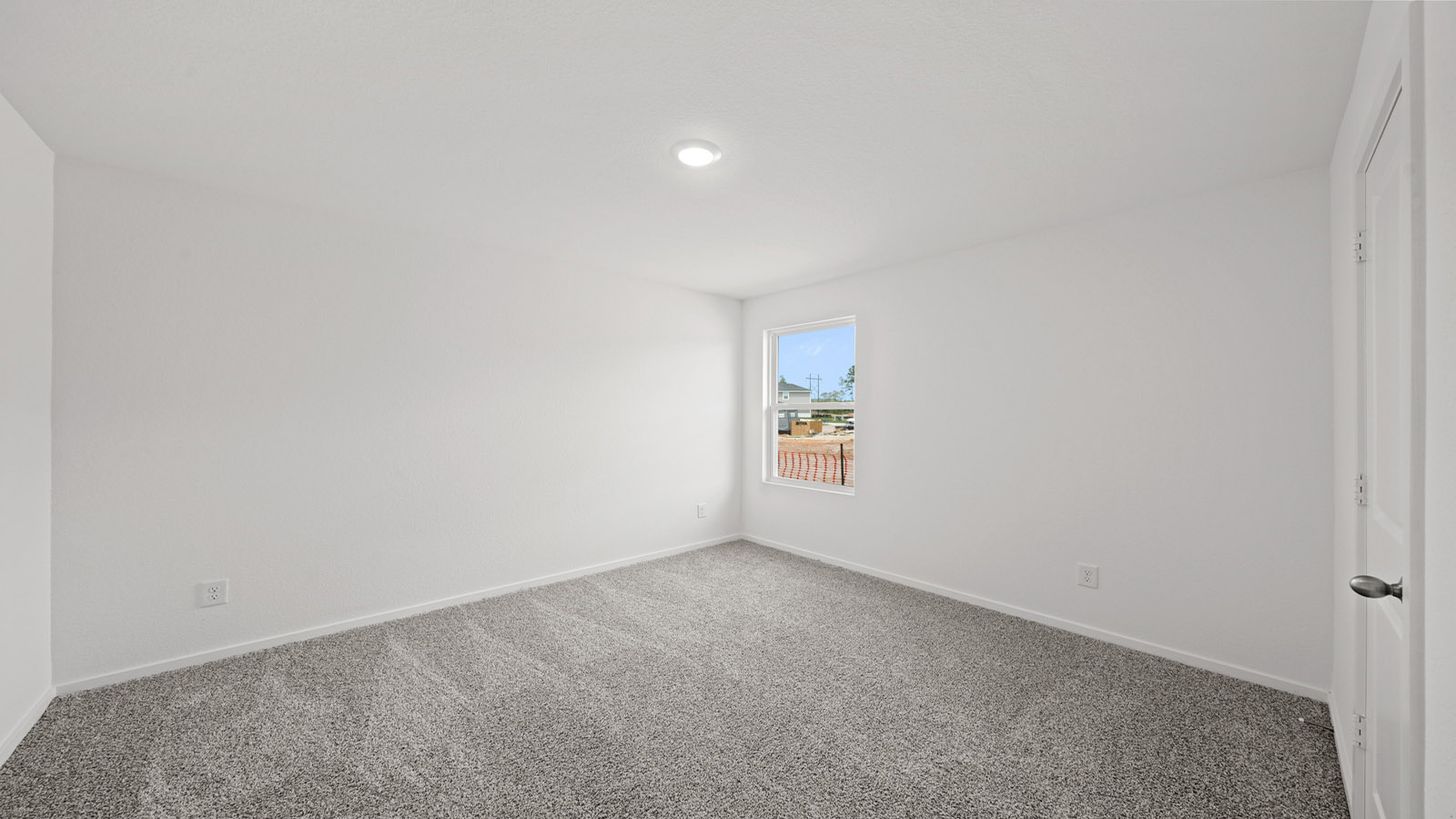 Secondary bedroom with carpet flooring