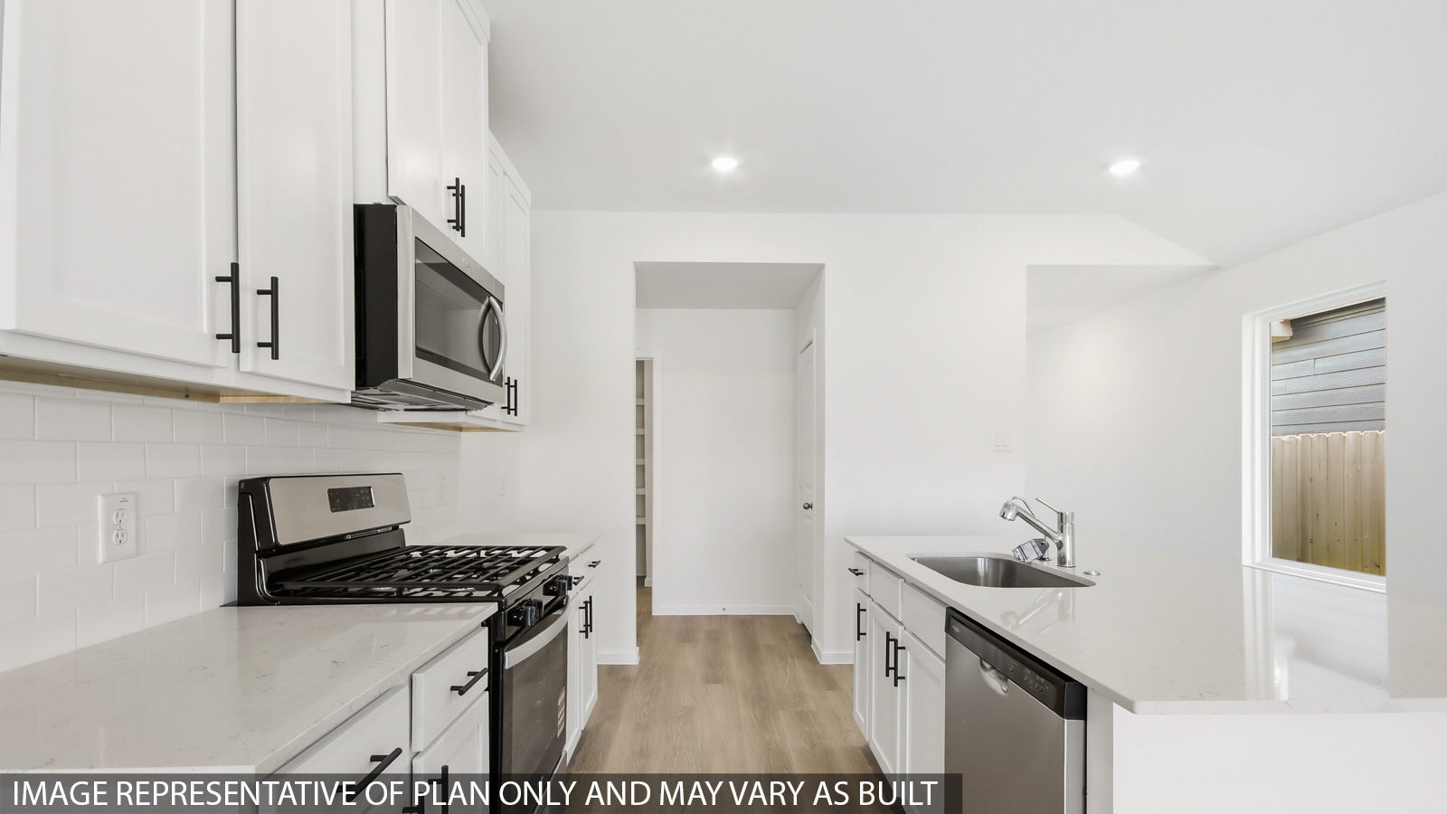 Kitchen with quartz countertops and an island and vinyl floor