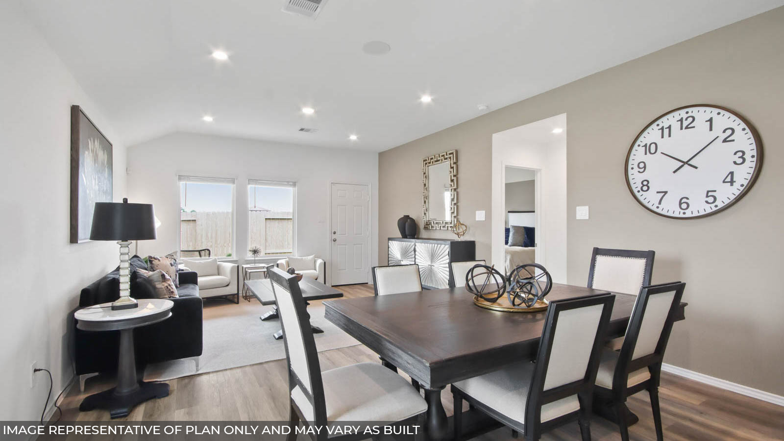 open concept living and dining area with vinyl flooring, quartz countertops, and stainless steel appliances