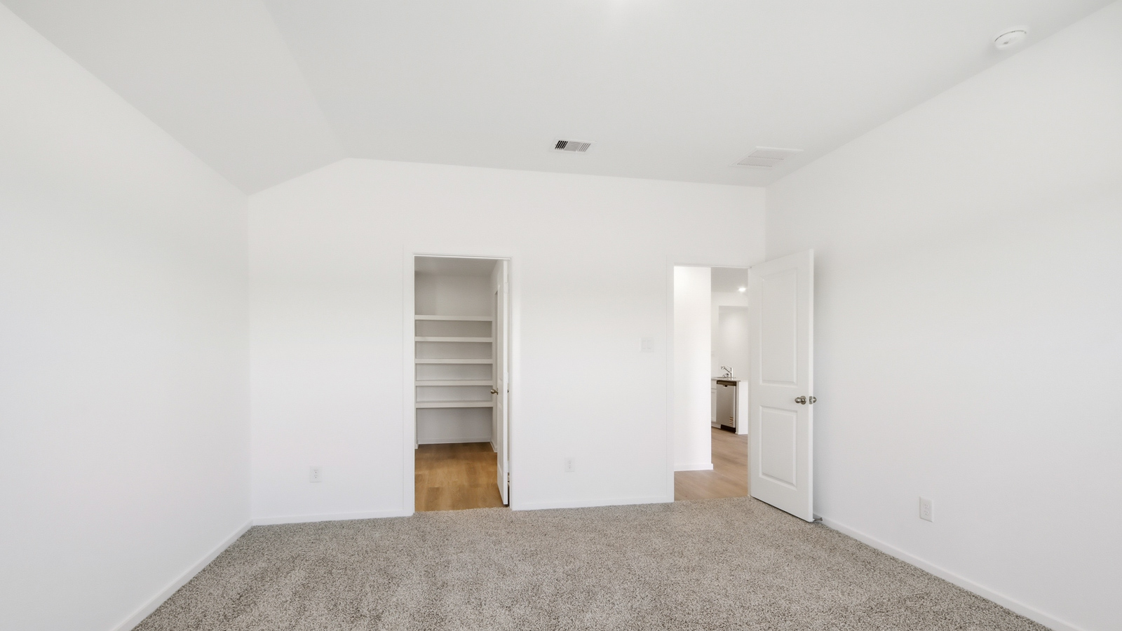 primary bedroom with carpet flooring