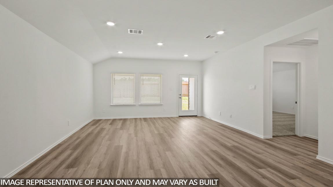 open concept livving and dining area with vinyl flooring, quartz countertops, and large windows in Hockley, TX